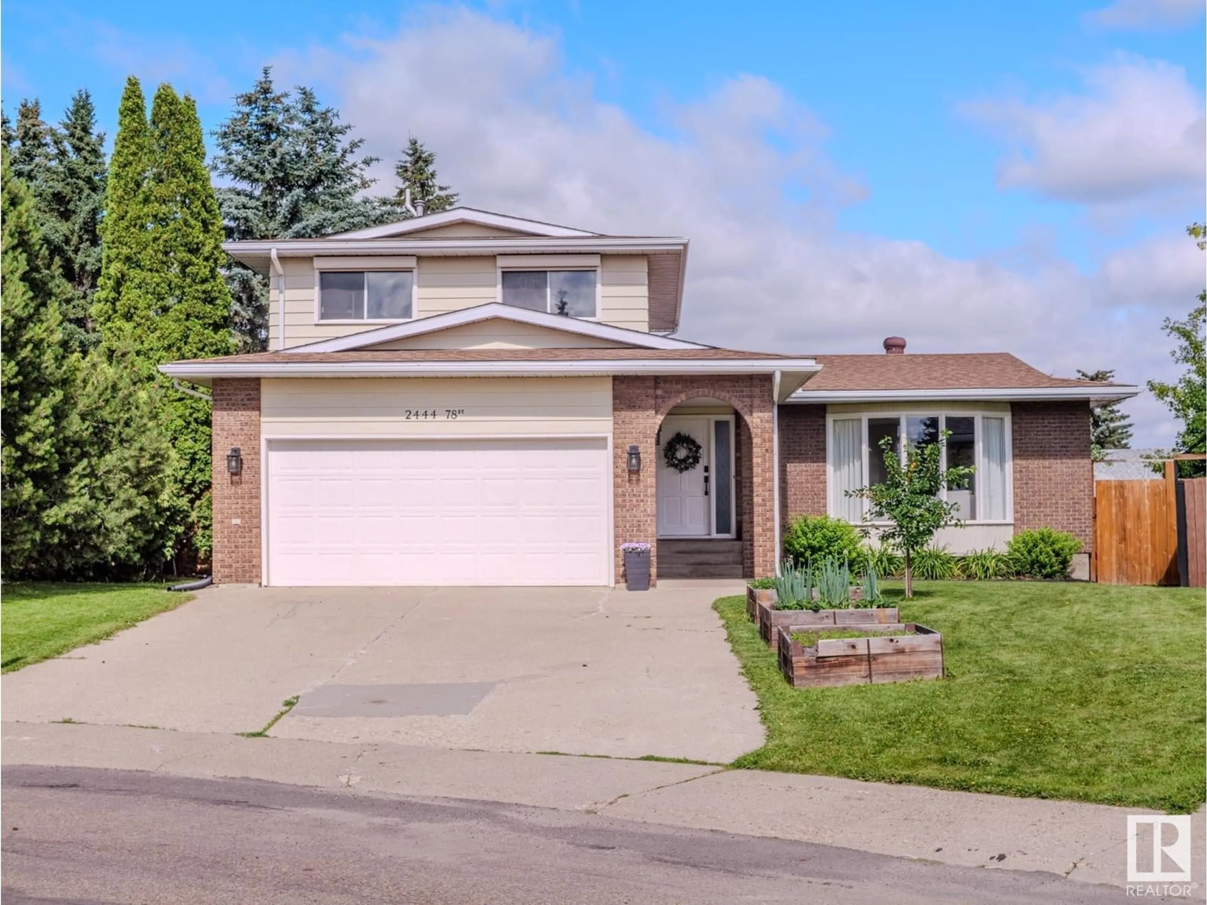 Home with vinyl exterior material, street for 2444 78 ST, Edmonton Alberta T6K3W4