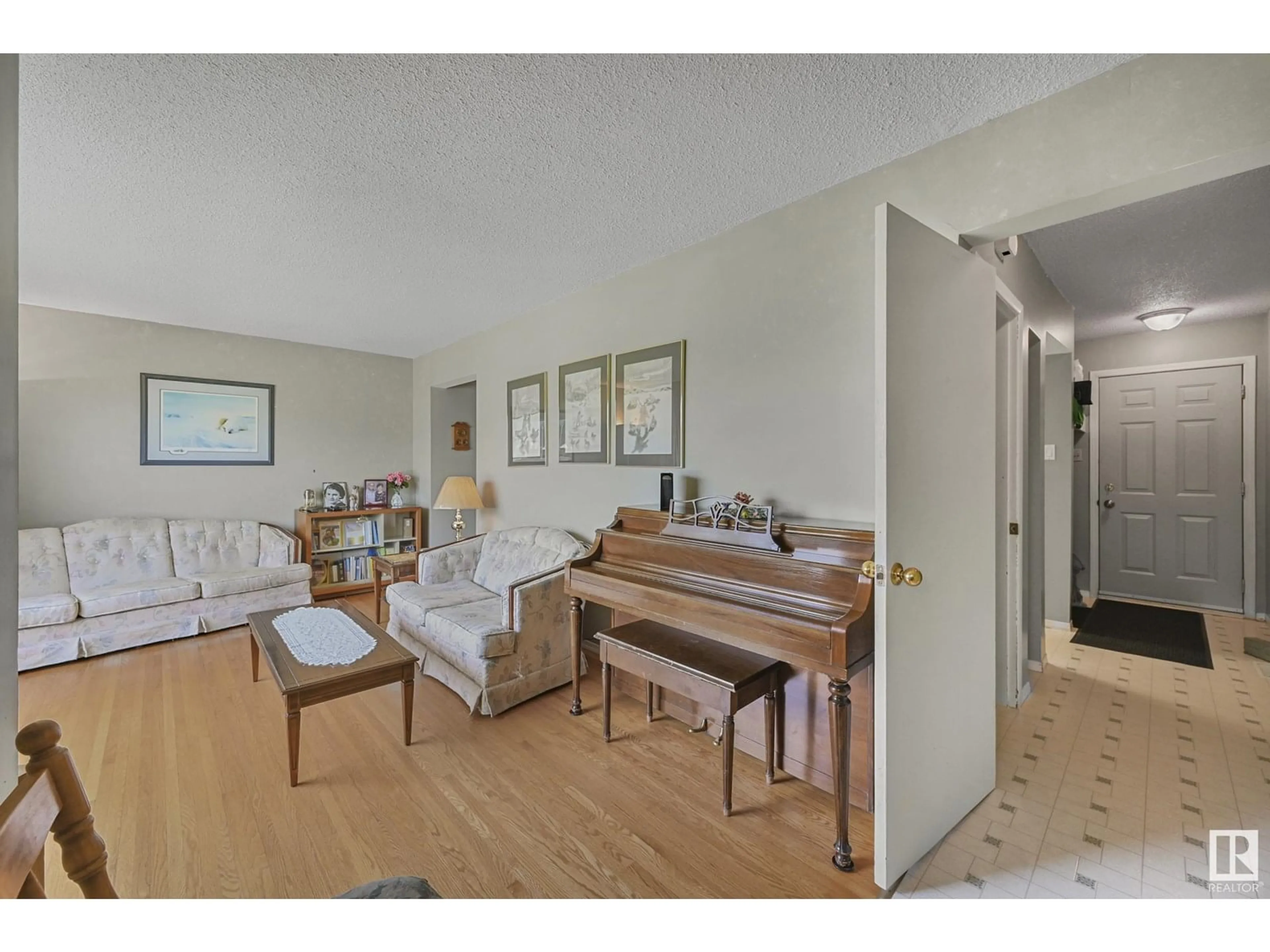 Living room with furniture, wood/laminate floor for 10317 132 AV, Edmonton Alberta T5E0Y8