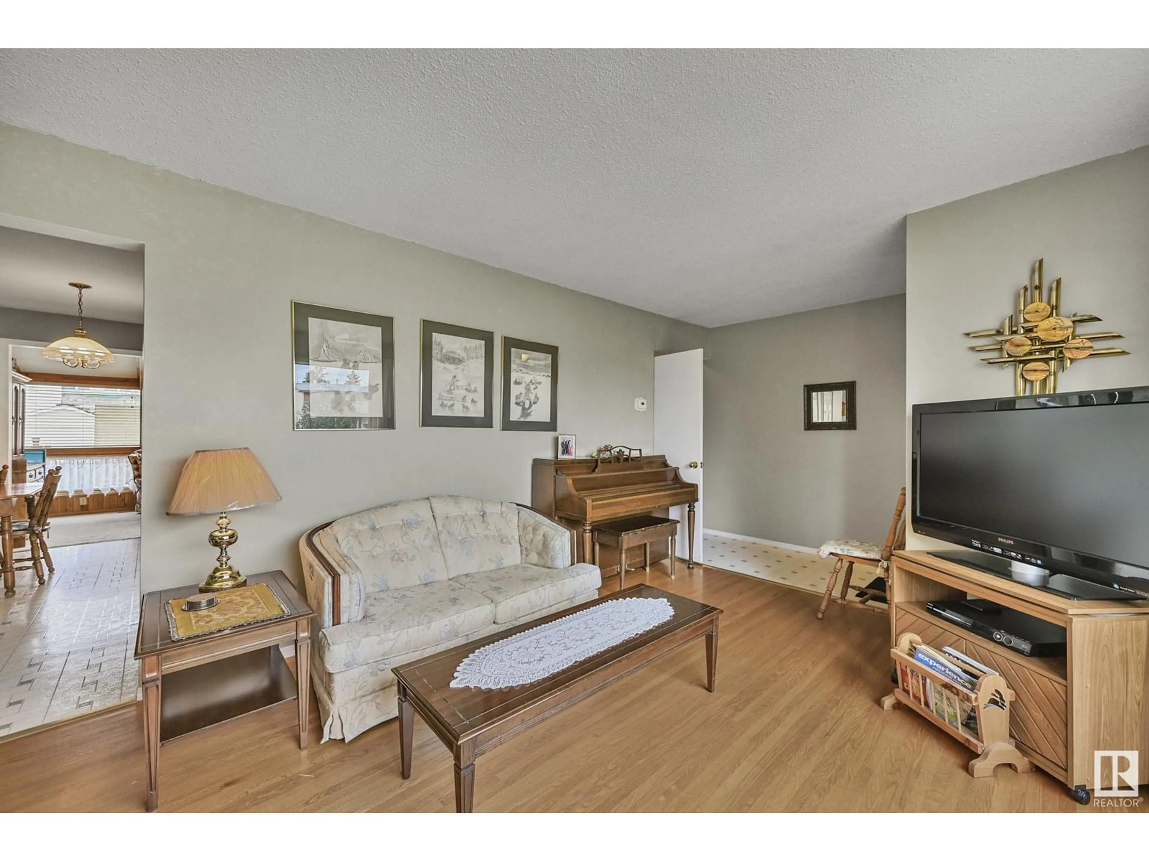 Living room with furniture, wood/laminate floor for 10317 132 AV, Edmonton Alberta T5E0Y8