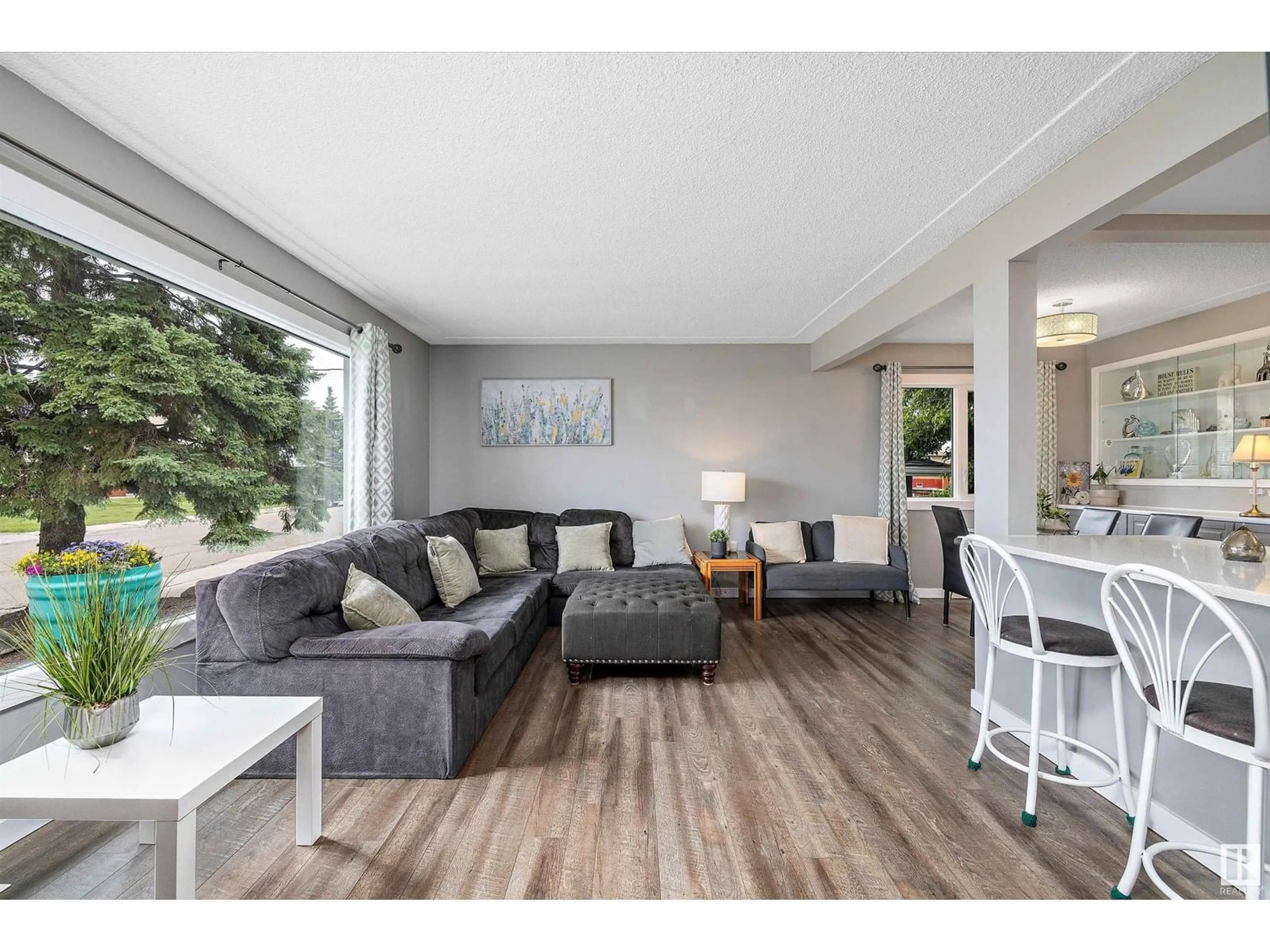 Living room with furniture, wood/laminate floor for 9444 52 ST, Edmonton Alberta T6B1G7