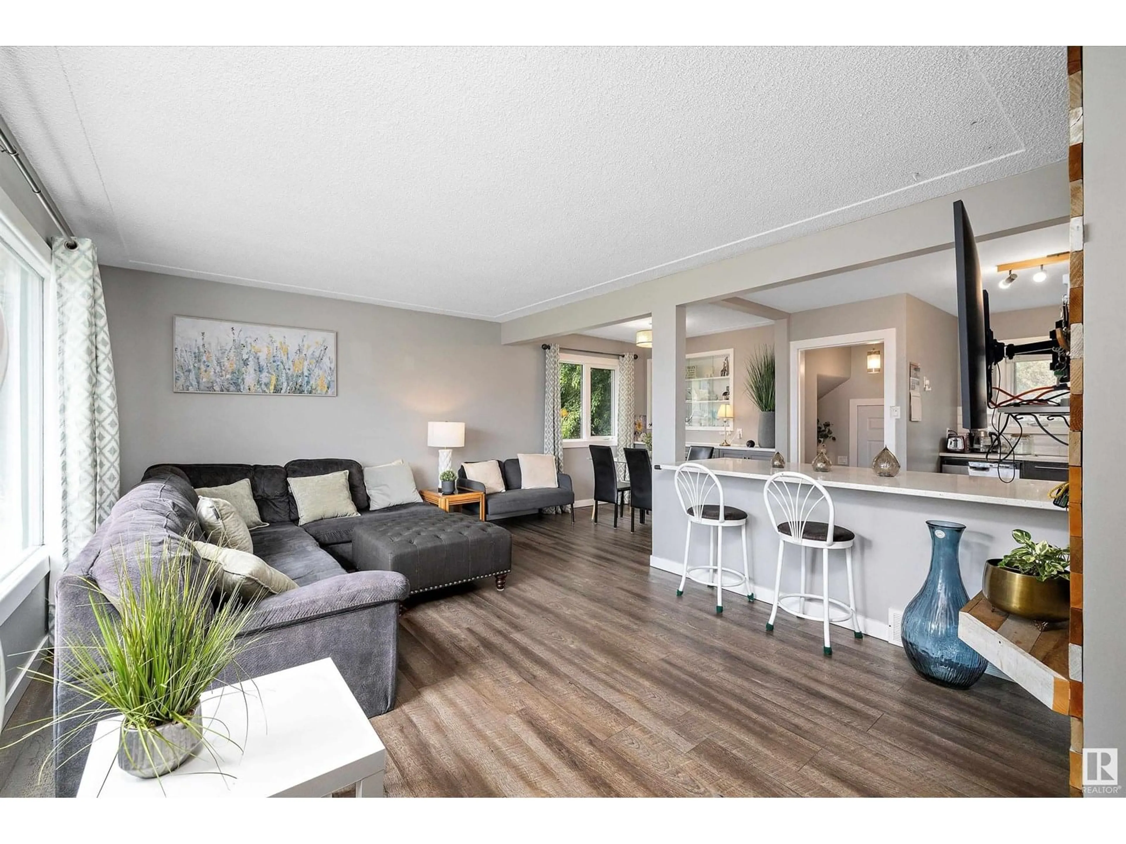 Living room with furniture, wood/laminate floor for 9444 52 ST, Edmonton Alberta T6B1G7