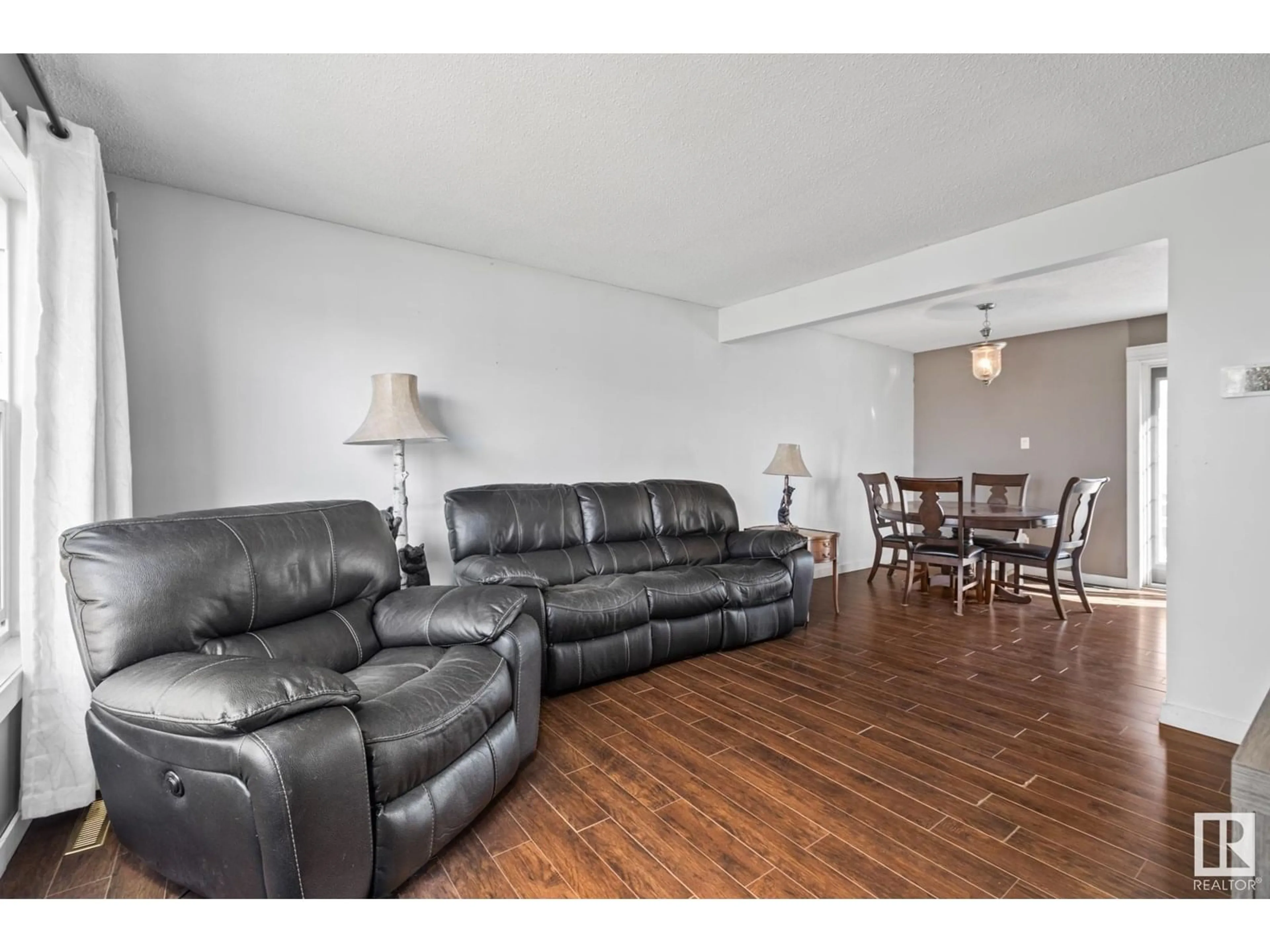 Living room with furniture, wood/laminate floor for 7111 130A AV, Edmonton Alberta T5C1Y8