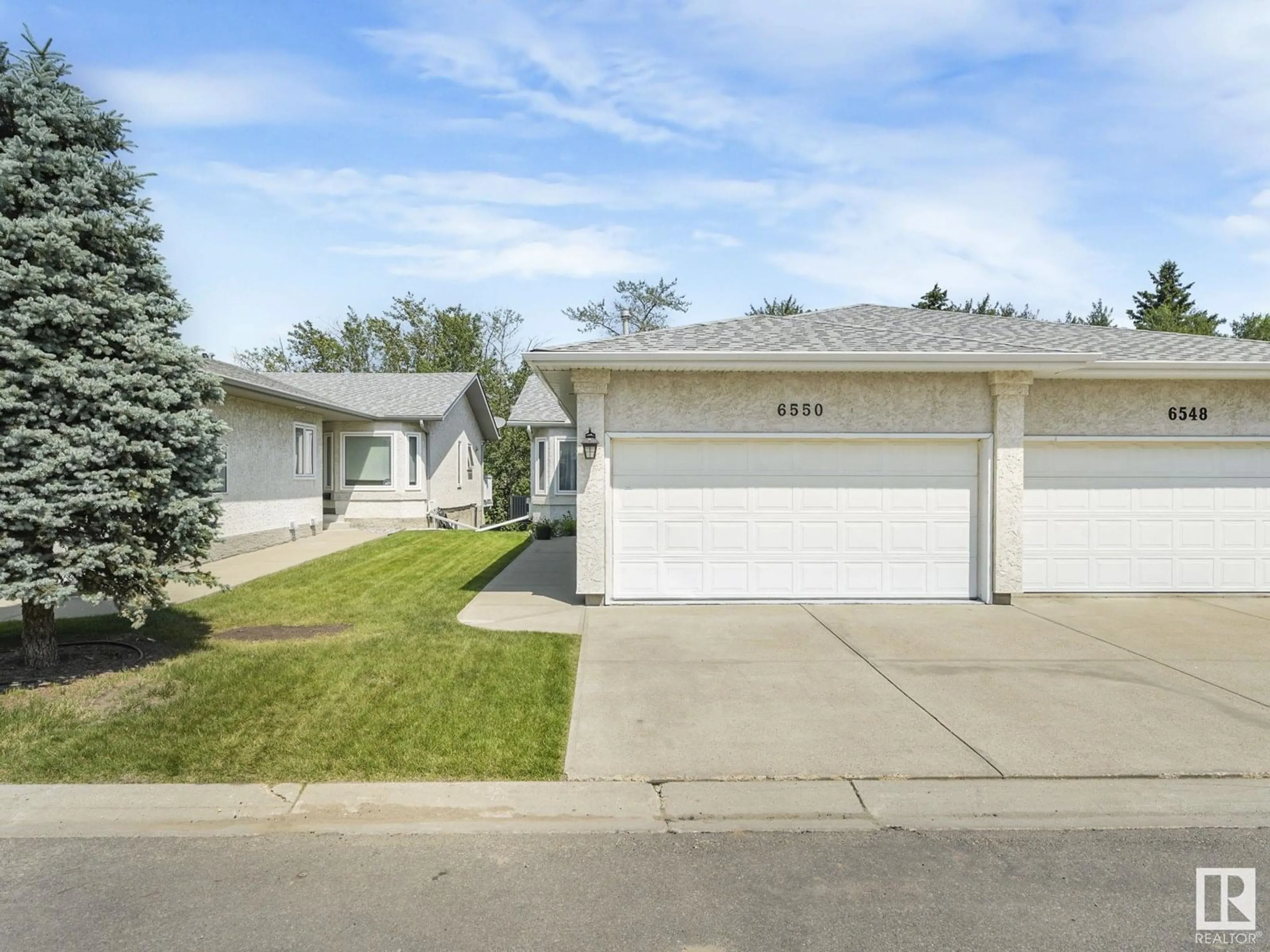 Home with vinyl exterior material, street for 6550 158 AV, Edmonton Alberta T5X2S7