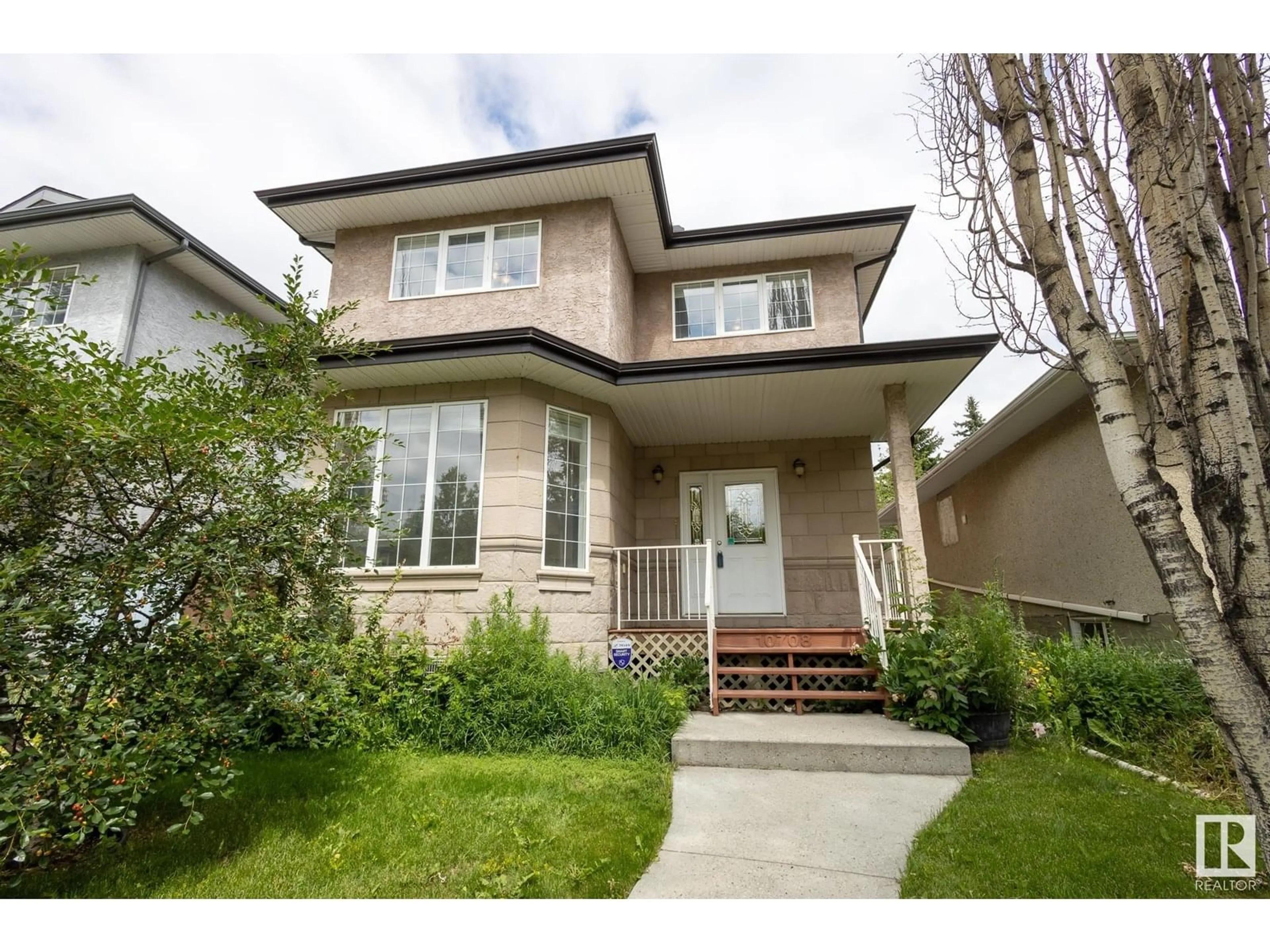 Home with vinyl exterior material, street for 10708 76 AV, Edmonton Alberta T6E1L7