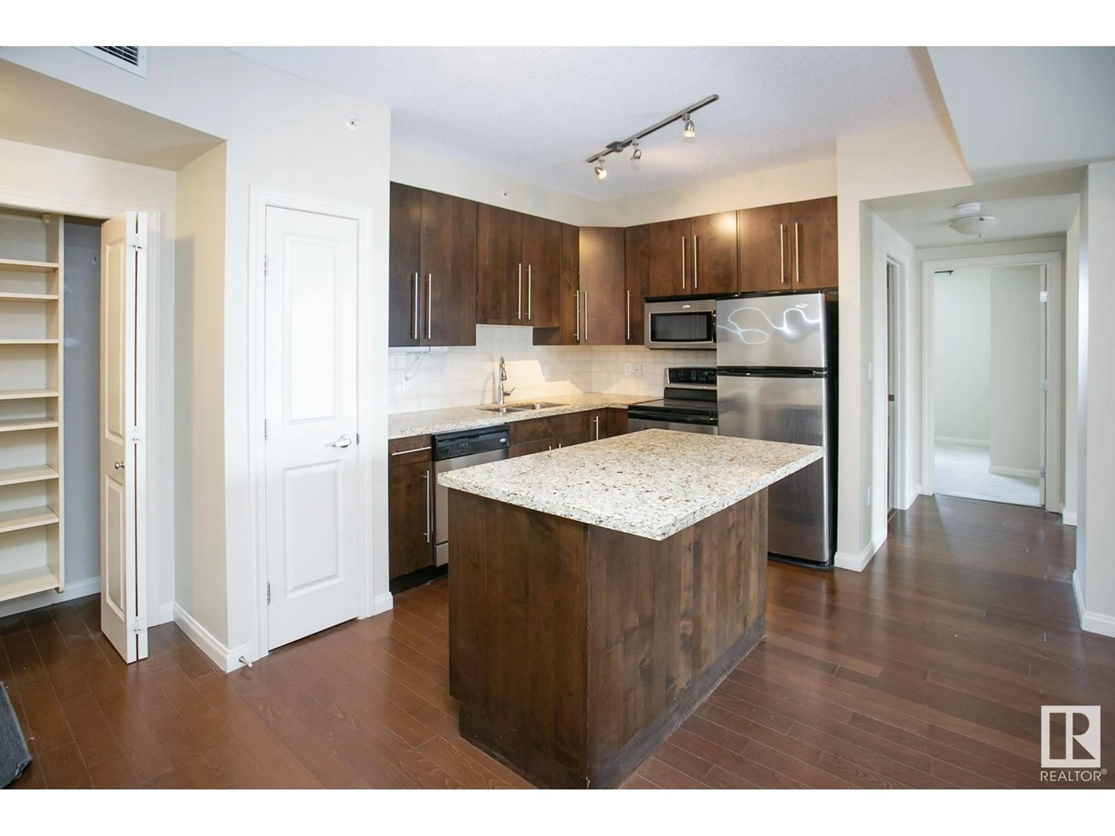 Open concept kitchen, wood/laminate floor for #303 - 9819 104 ST, Edmonton Alberta T5K0Y8
