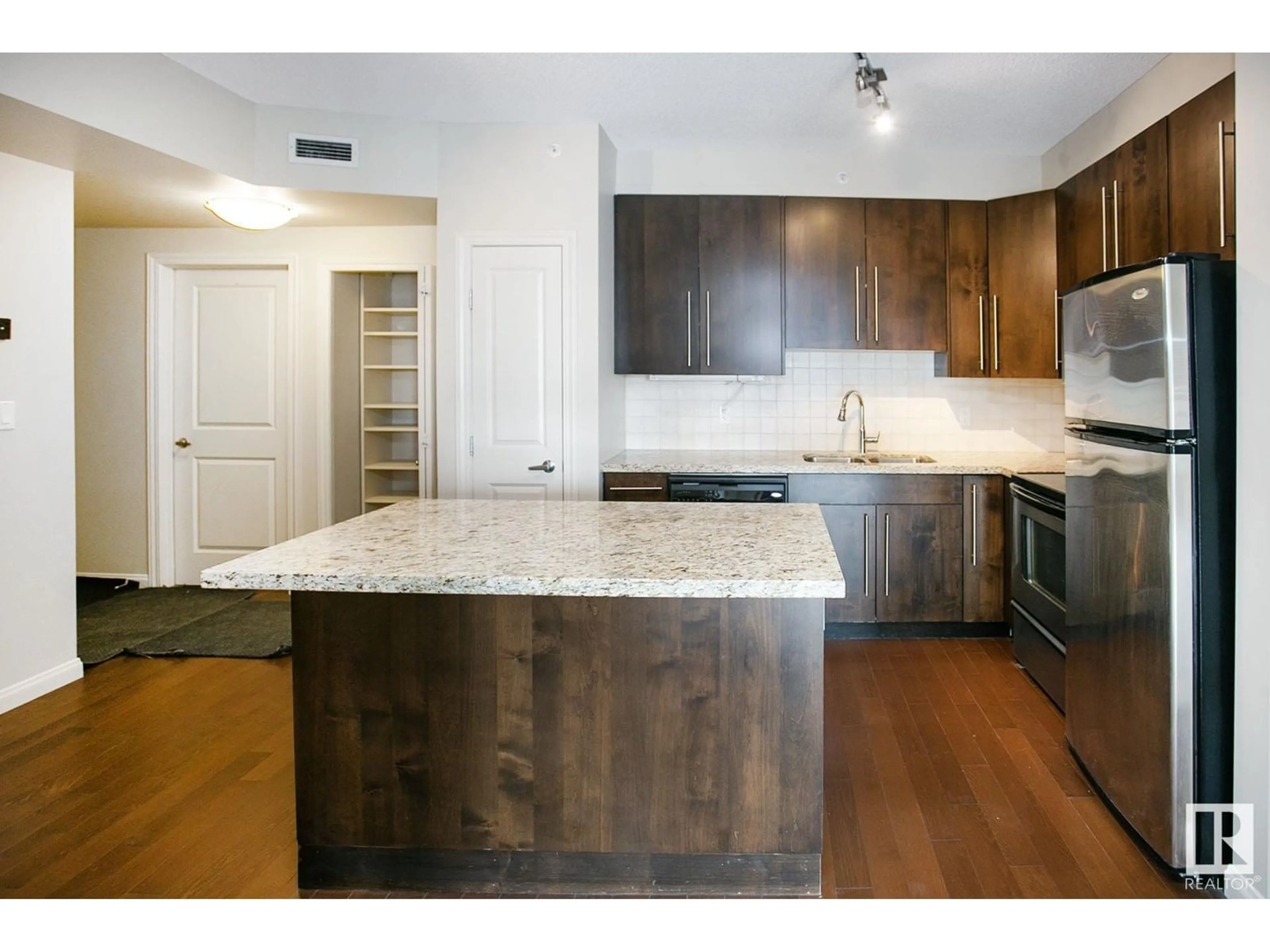 Open concept kitchen, wood/laminate floor for #303 - 9819 104 ST, Edmonton Alberta T5K0Y8