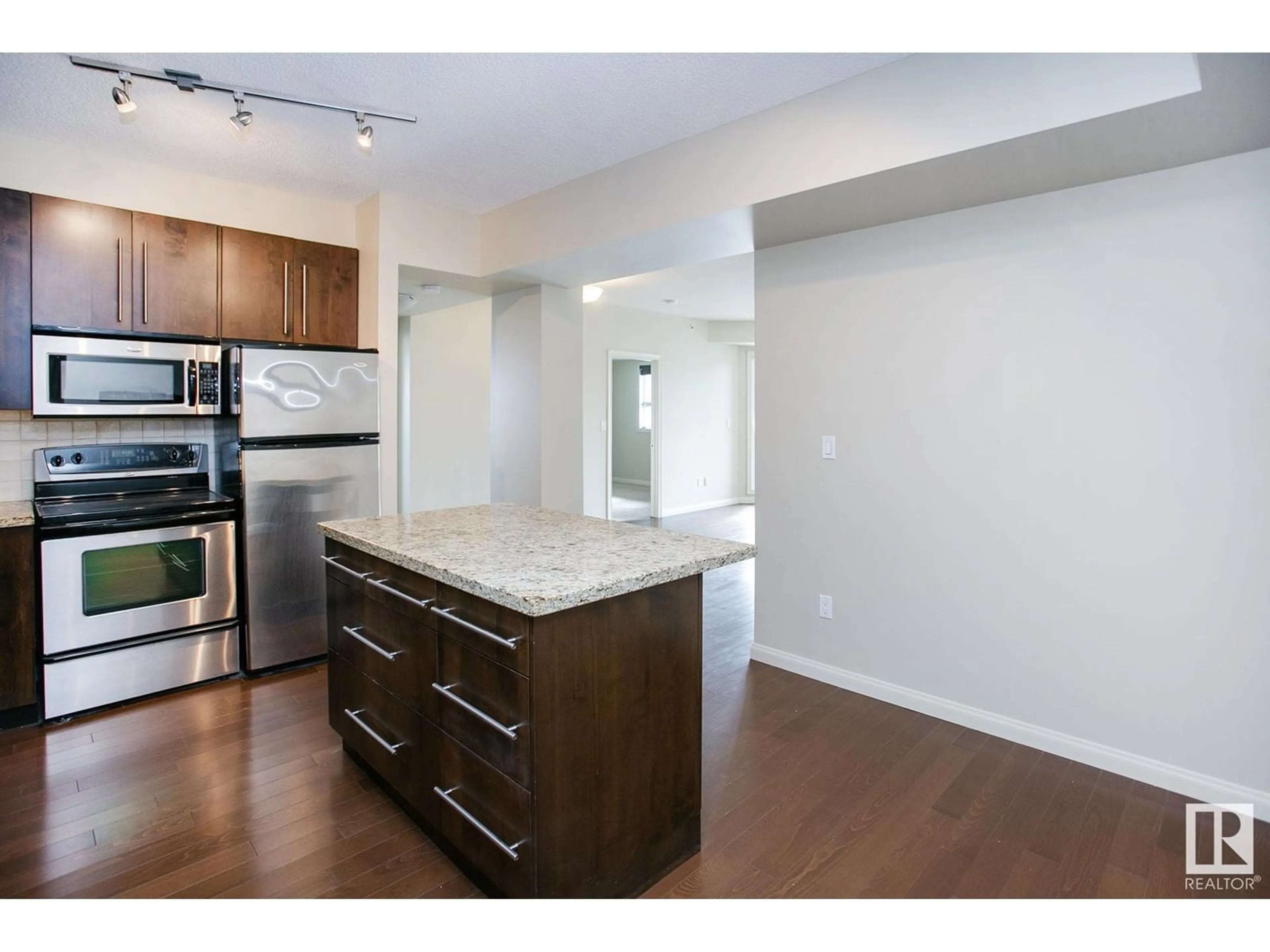 Open concept kitchen, wood/laminate floor for #303 - 9819 104 ST, Edmonton Alberta T5K0Y8