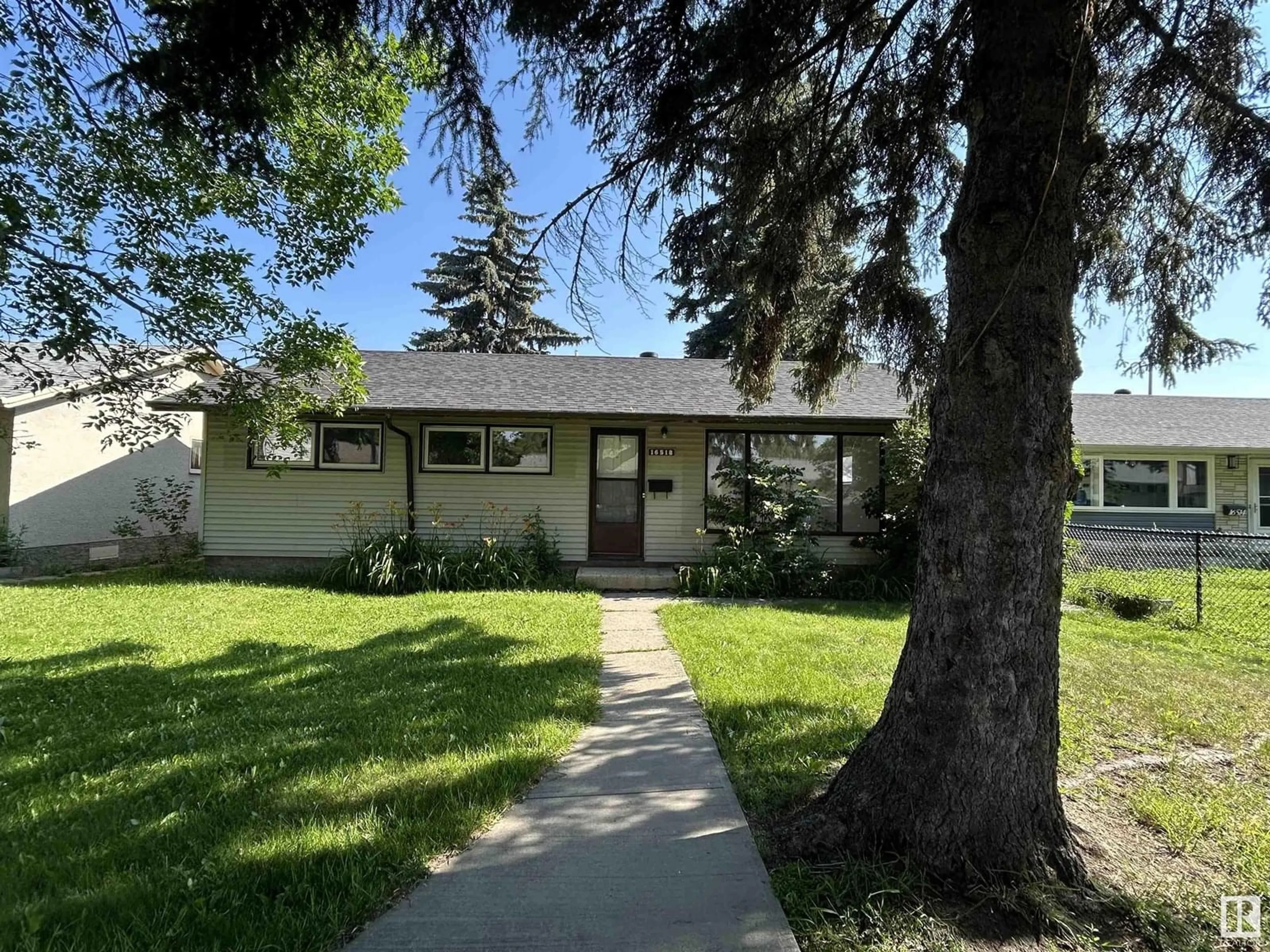 Home with vinyl exterior material, street for 16518 106 AV, Edmonton Alberta T5P0W9