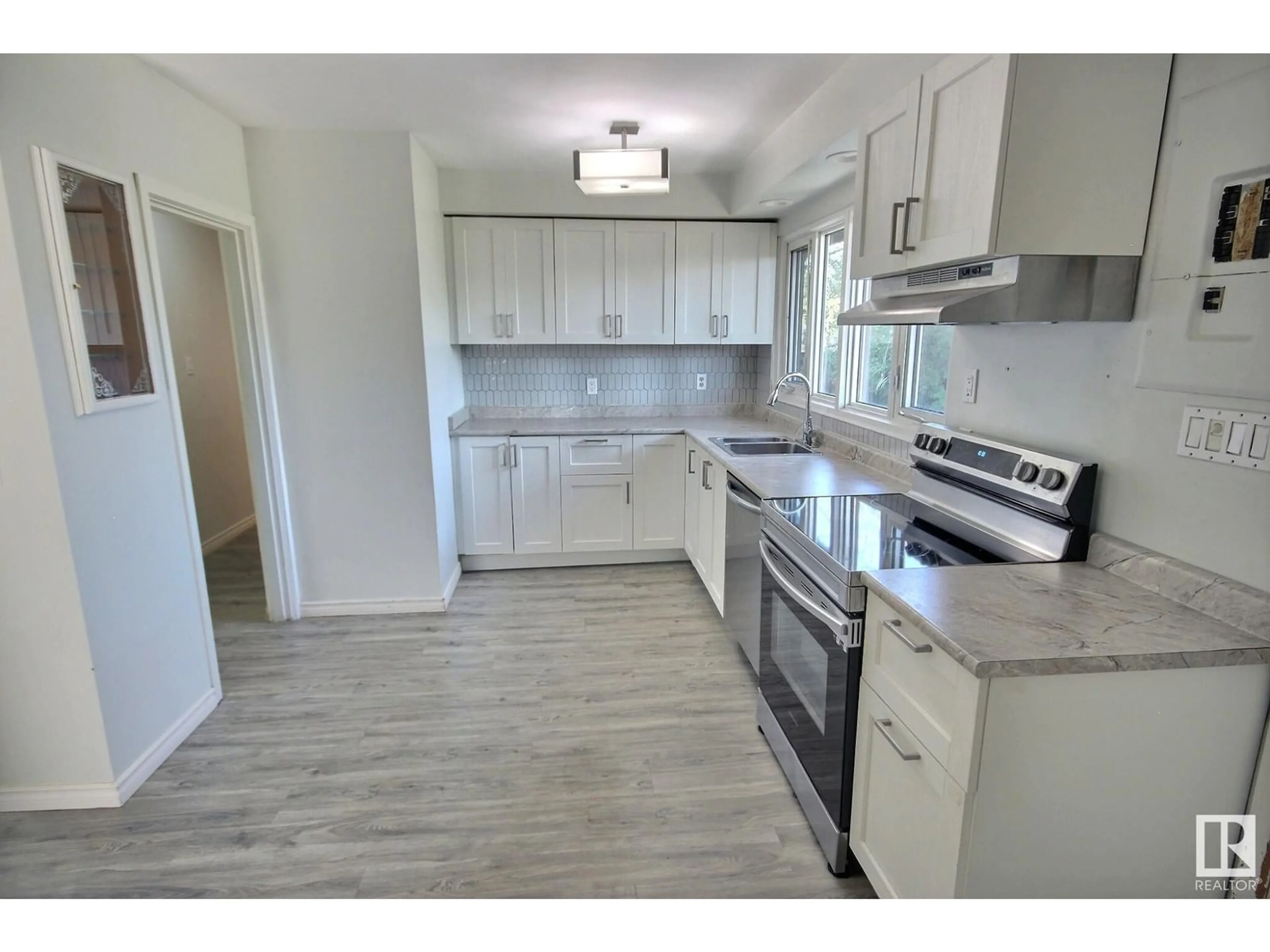 Open concept kitchen, wood/laminate floor for 16518 106 AV, Edmonton Alberta T5P0W9