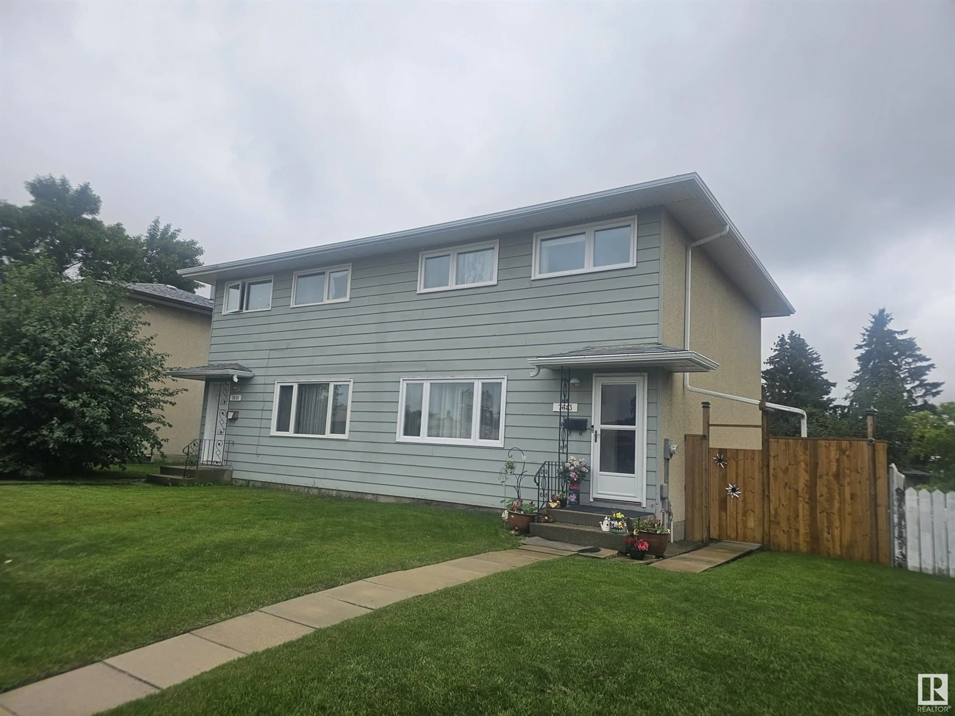 Home with vinyl exterior material, street for NW - 7613 144 AV, Edmonton Alberta T5C2R9