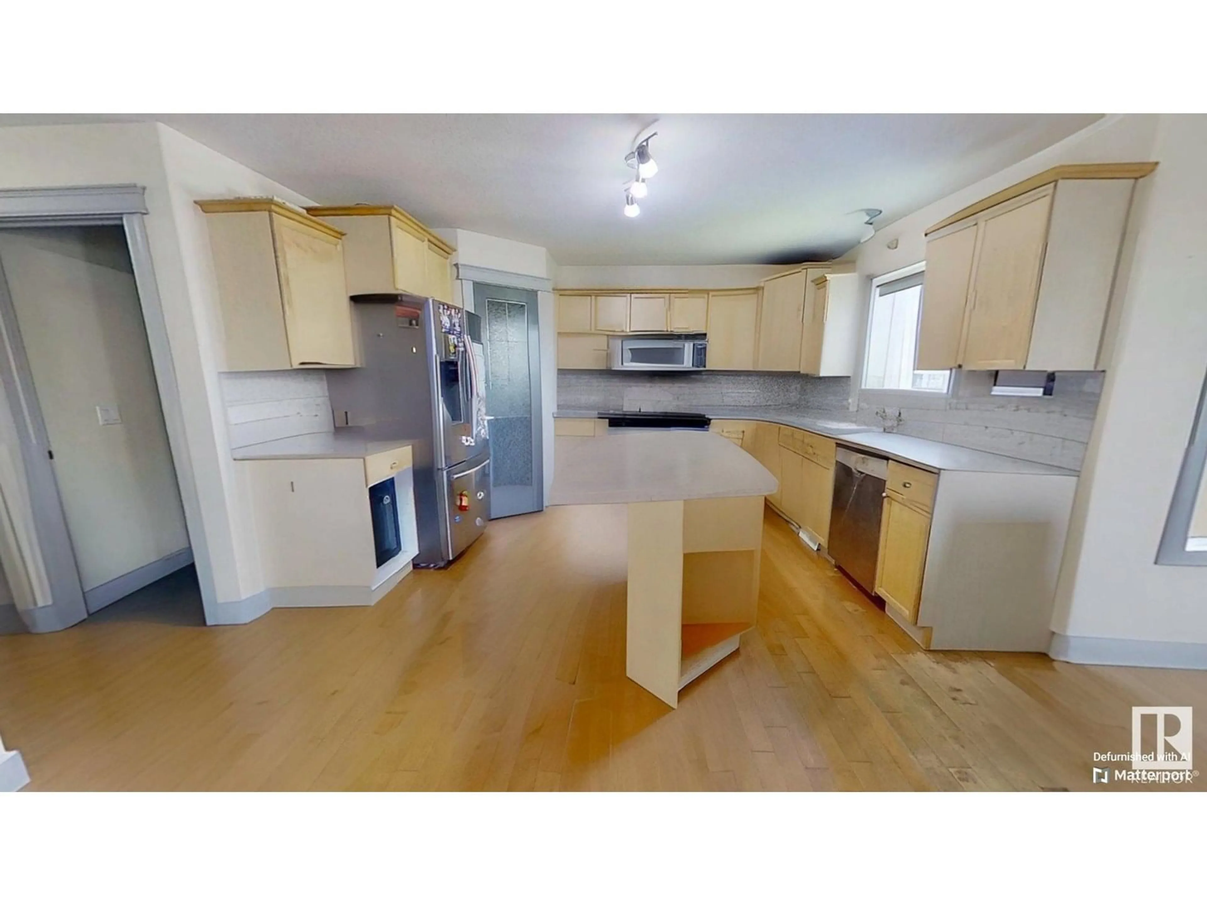 Open concept kitchen, wood/laminate floor for 32 CARRIERE CR, Beaumont Alberta T4X0A8