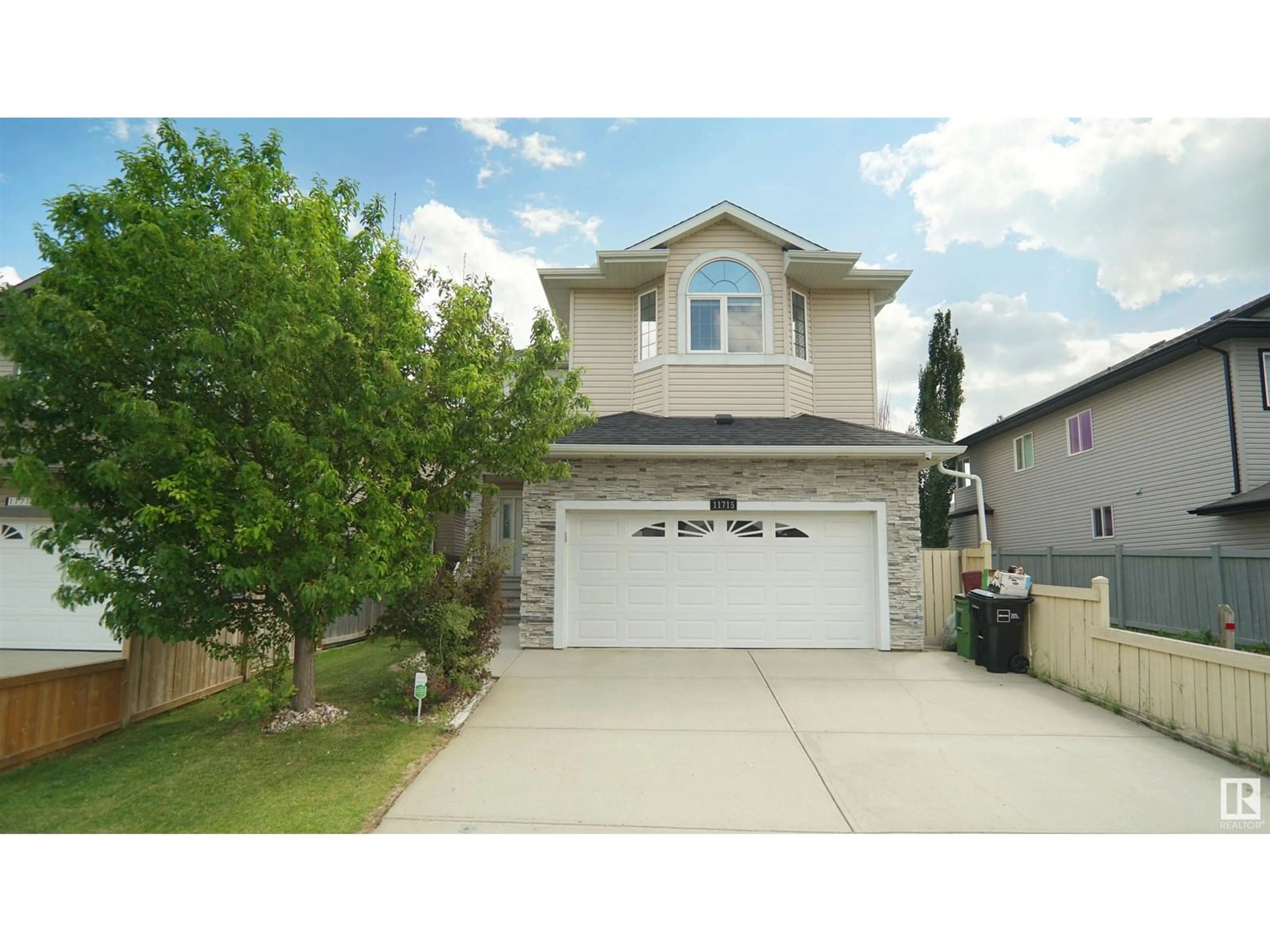 Home with vinyl exterior material, street for NW - 11715 174 AV, Edmonton Alberta T5X0A3