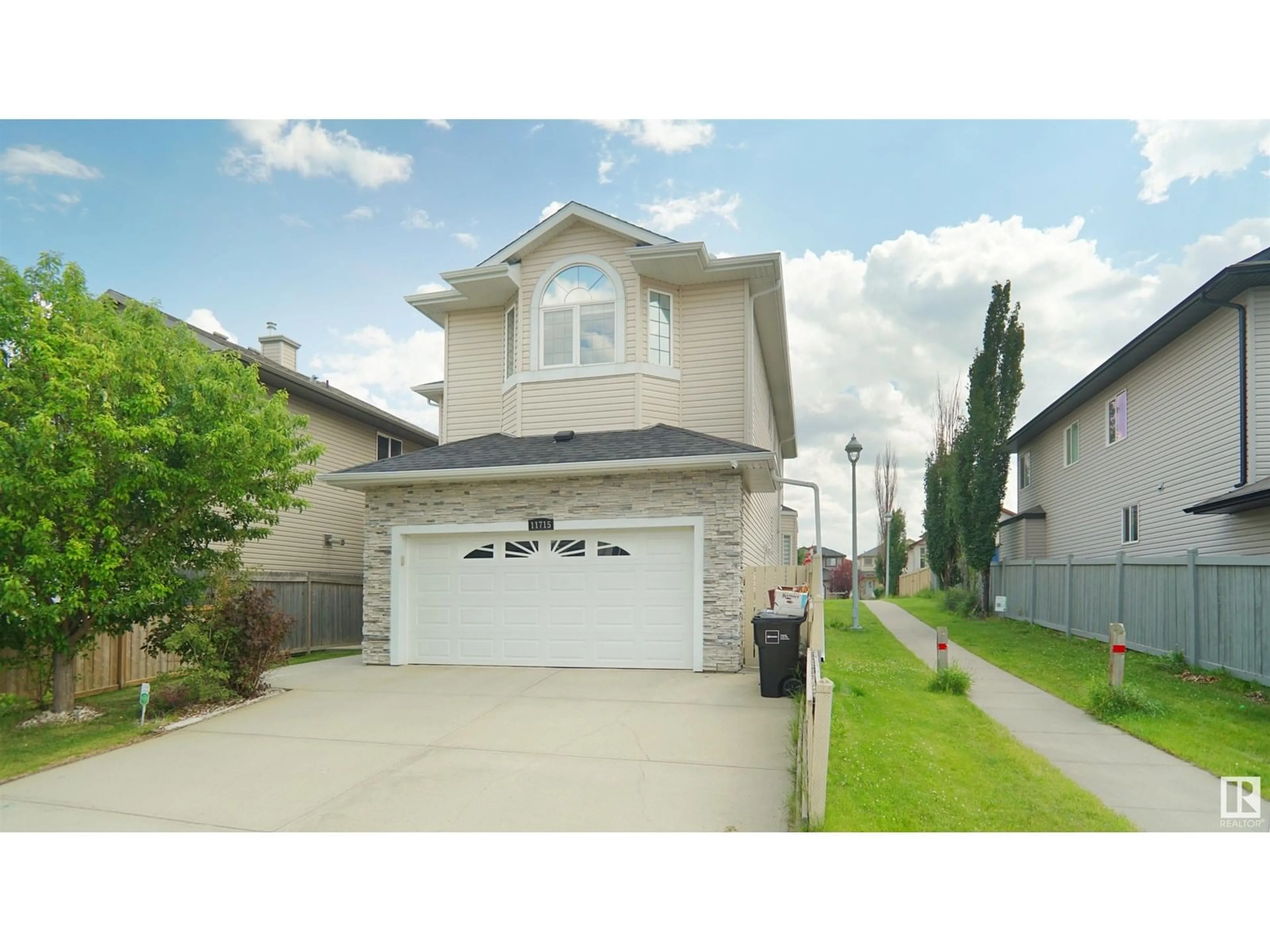 Home with vinyl exterior material, street for NW - 11715 174 AV, Edmonton Alberta T5X0A3