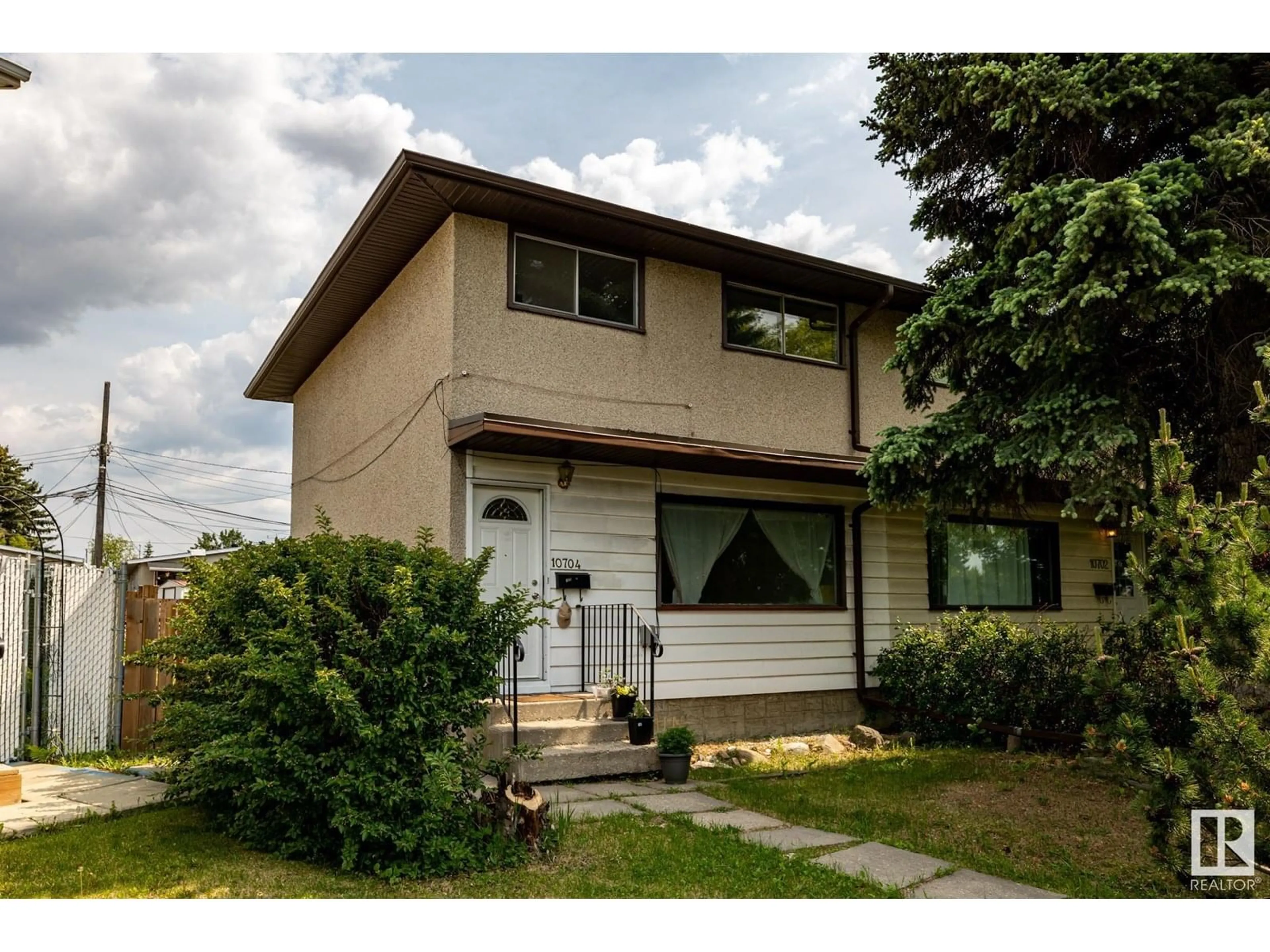 Home with vinyl exterior material, street for NW - 10704 51 AV, Edmonton Alberta T6G0L2