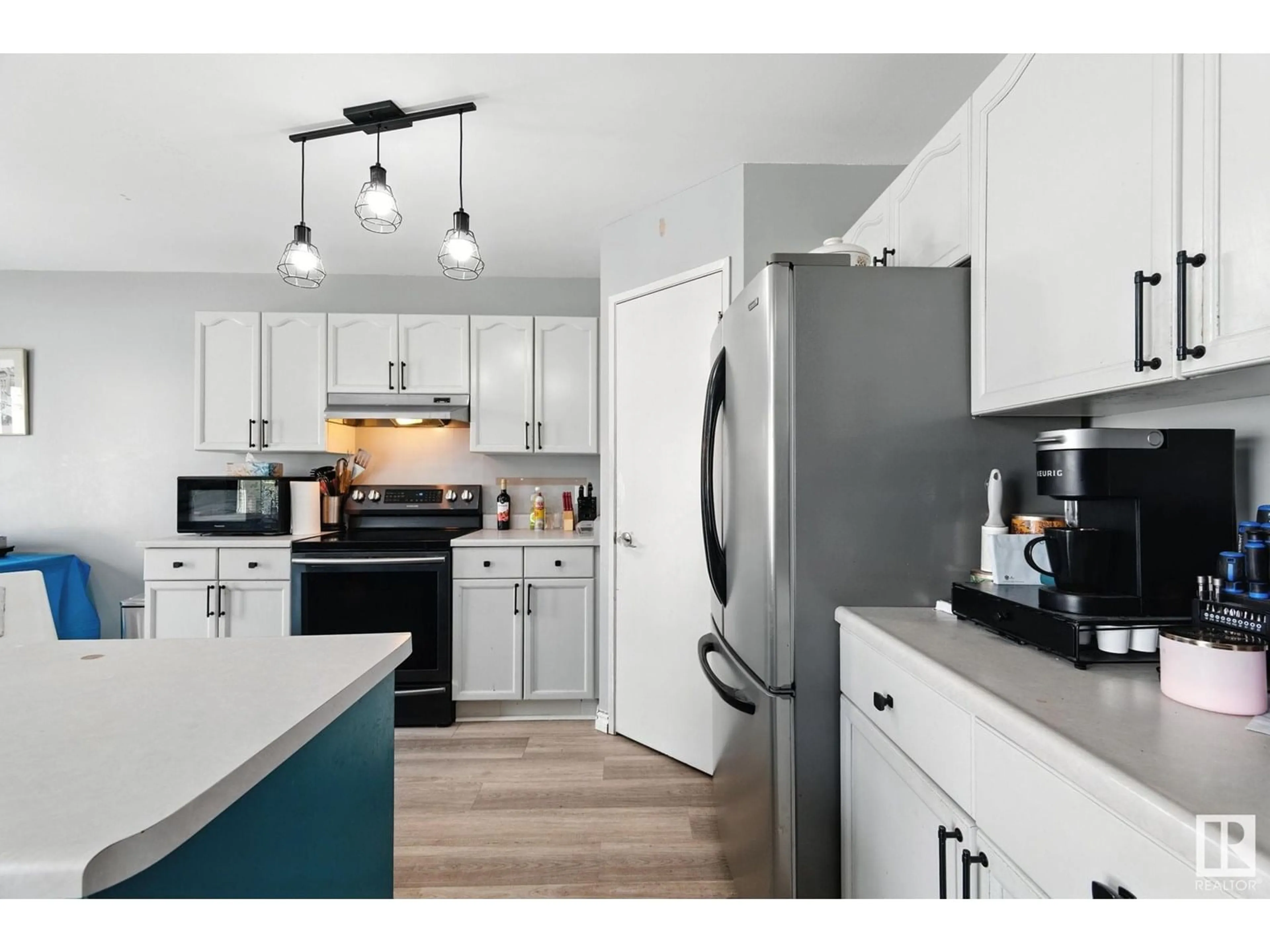 Open concept kitchen, wood/laminate floor for NW - 16225 58 ST, Edmonton Alberta T5Y2W2