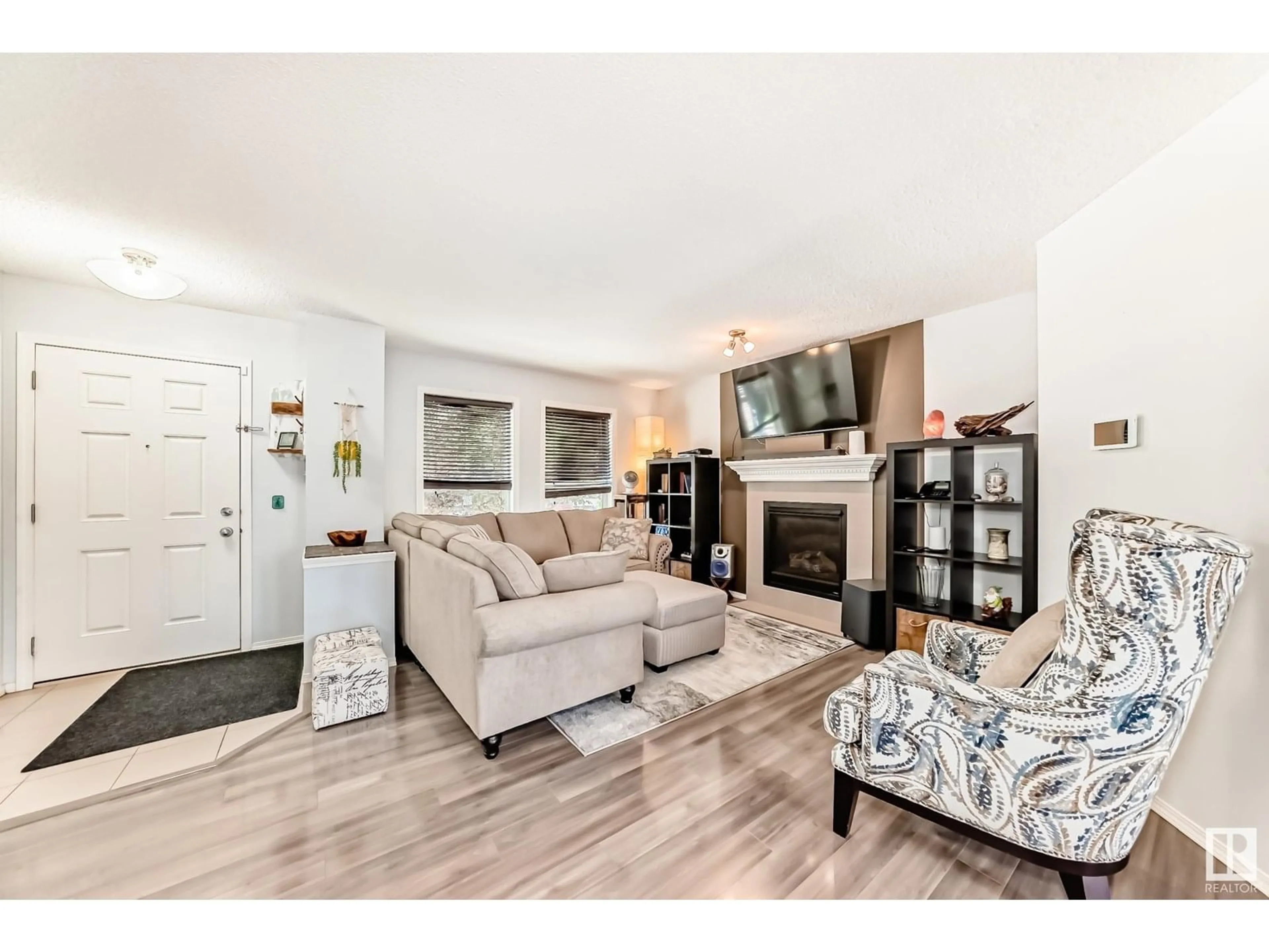 Living room with furniture, wood/laminate floor for NW - 6024 213 ST, Edmonton Alberta T6M0J9