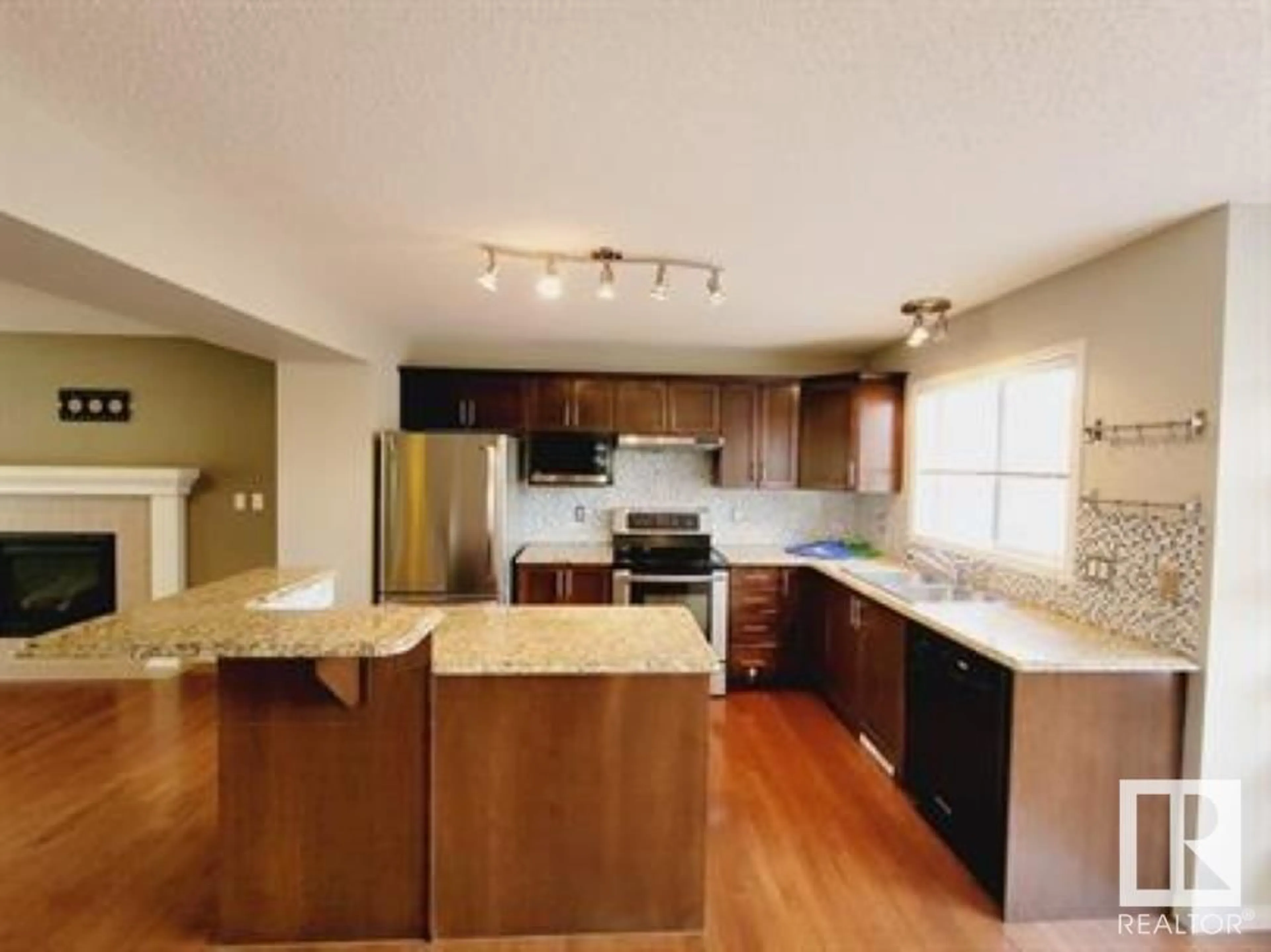 Open concept kitchen, wood/laminate floor for 7707 SCHMID CR, Edmonton Alberta T6R0K6
