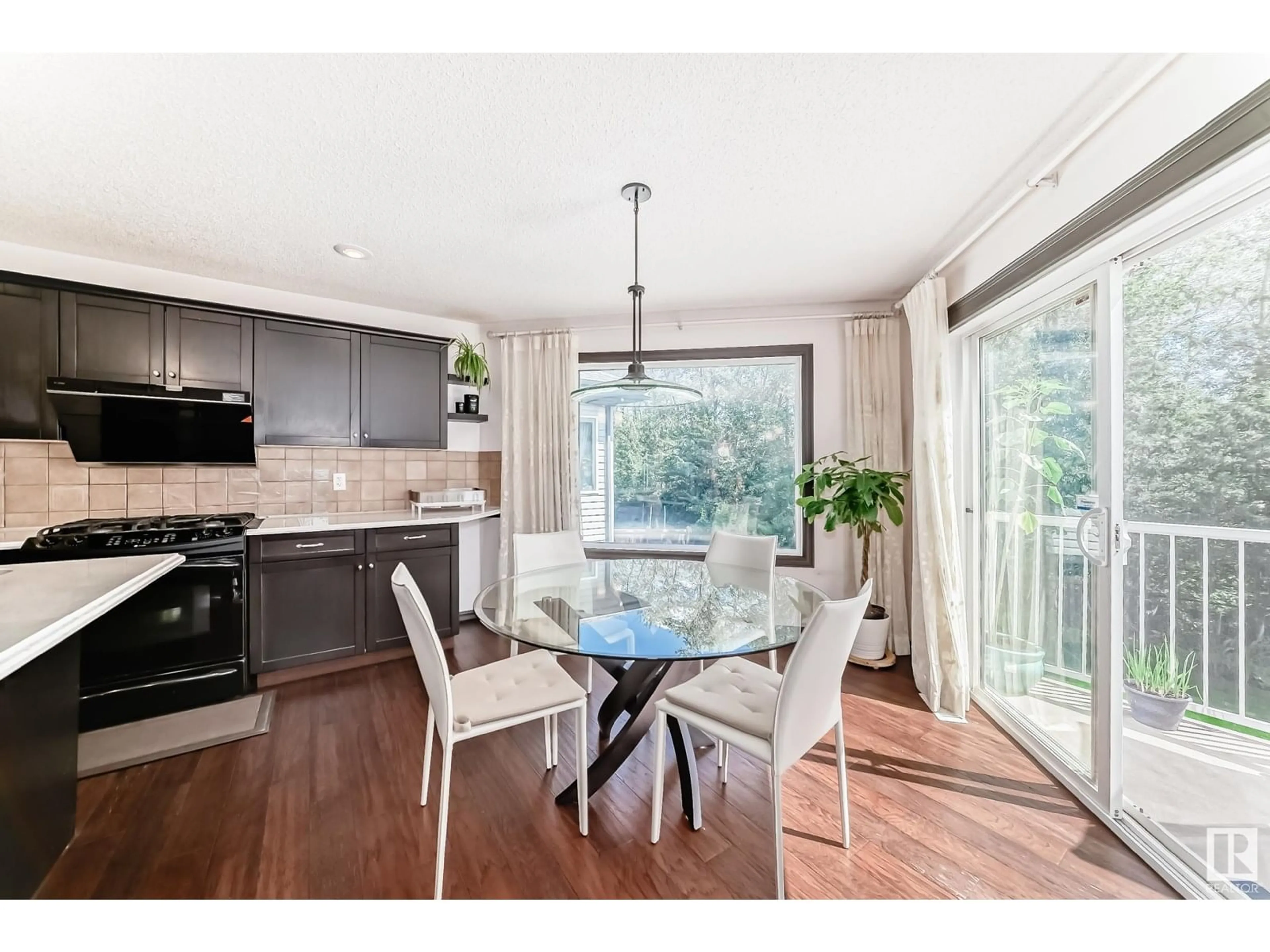 Open concept kitchen, wood/laminate floor for 9107 205 ST NW, Edmonton Alberta T5T0X1