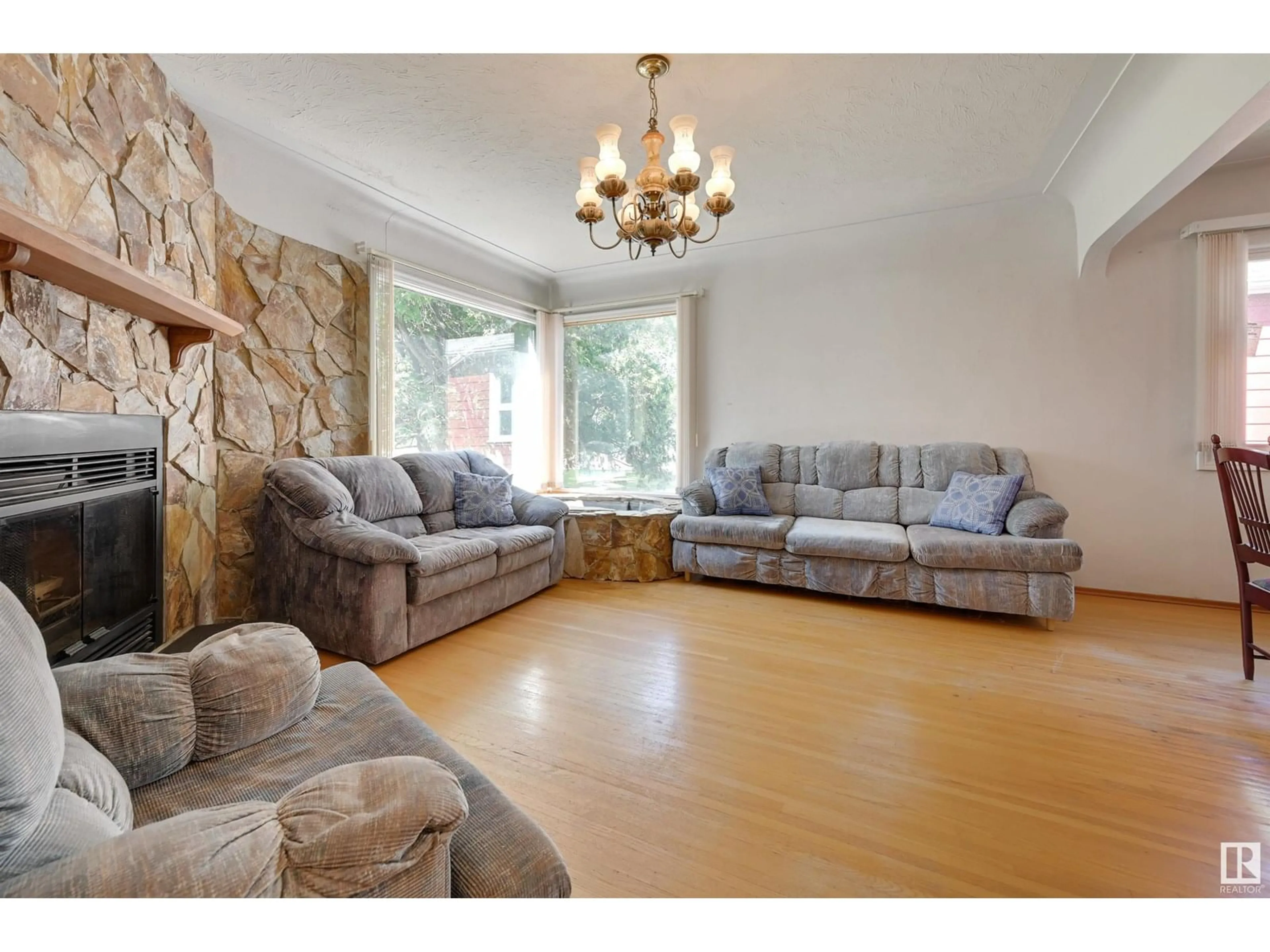 Living room with furniture, wood/laminate floor for NW - 11624 110A AV, Edmonton Alberta T5H1K6