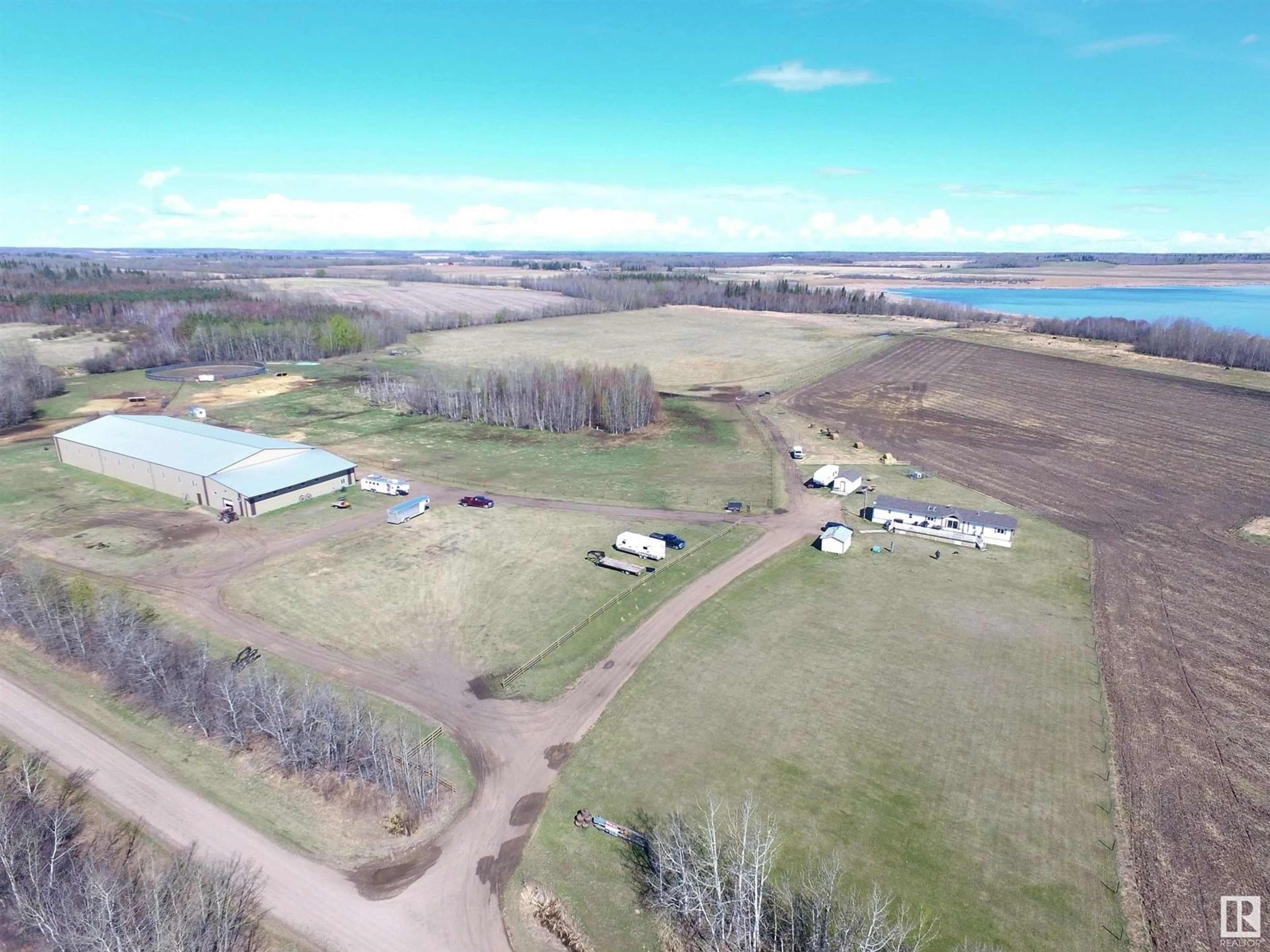 A pic from outside/outdoor area/front of a property/back of a property/a pic from drone, water/lake/river/ocean view for 2310 TWP ROAD 554, Rural Lac Ste. Anne County Alberta T0E1V0
