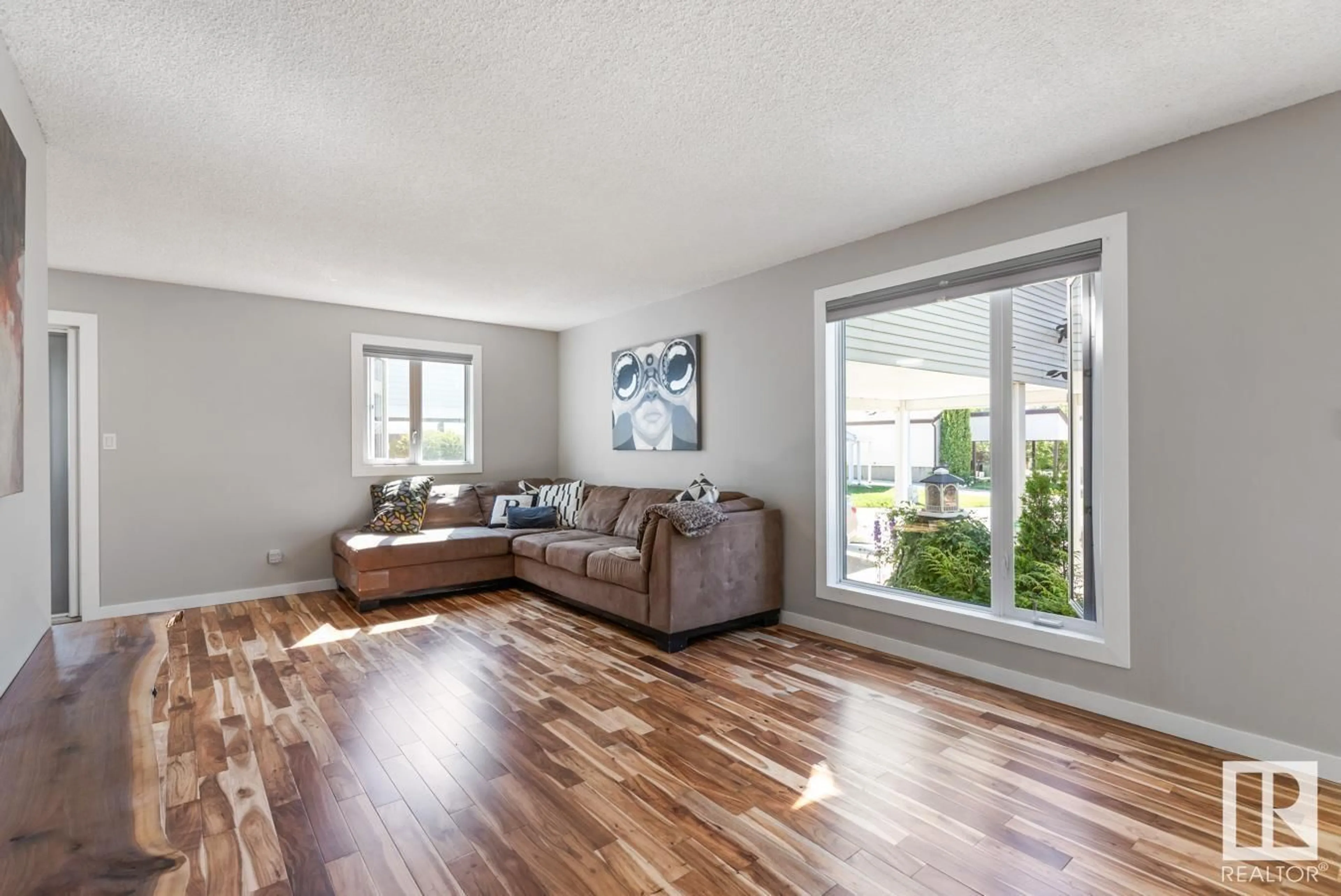 Living room with furniture, wood/laminate floor for 5712 92C AV, Edmonton Alberta T6B2K6