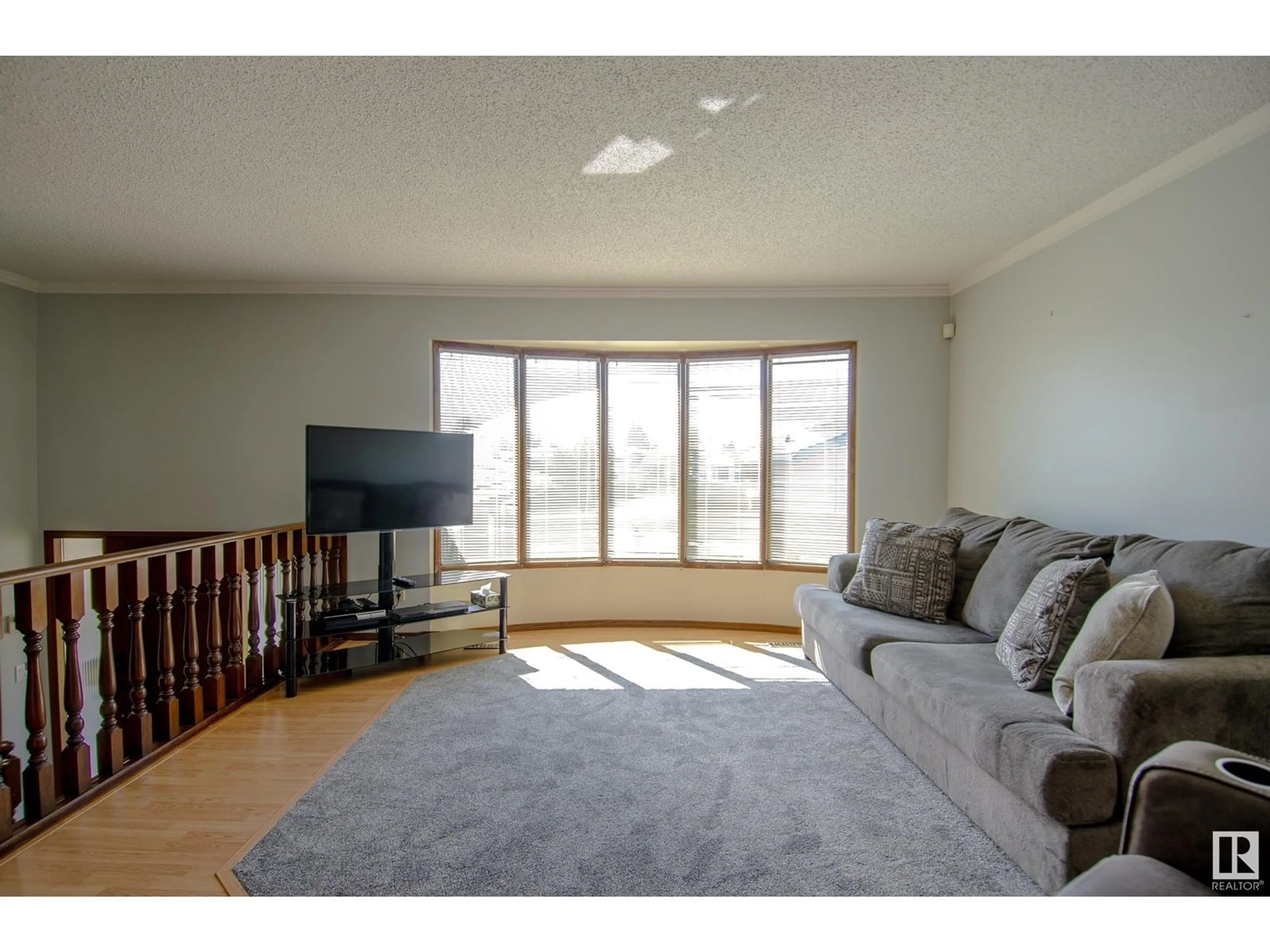 Living room with furniture, wood/laminate floor for 136 DUNLUCE RD, Edmonton Alberta T5X4N9
