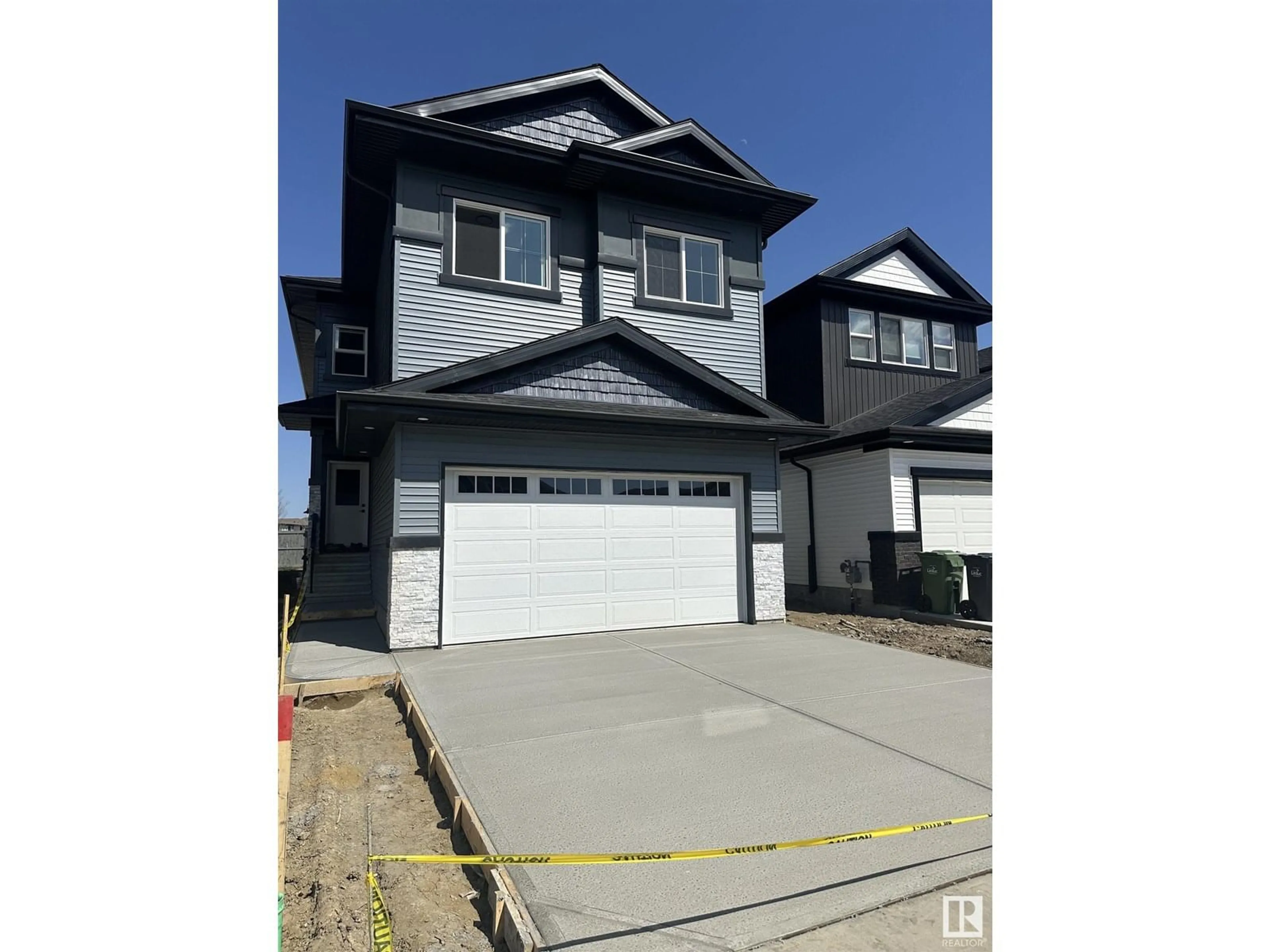 Home with vinyl exterior material, street for 205 KETTYL CO, Leduc Alberta T9E1S1