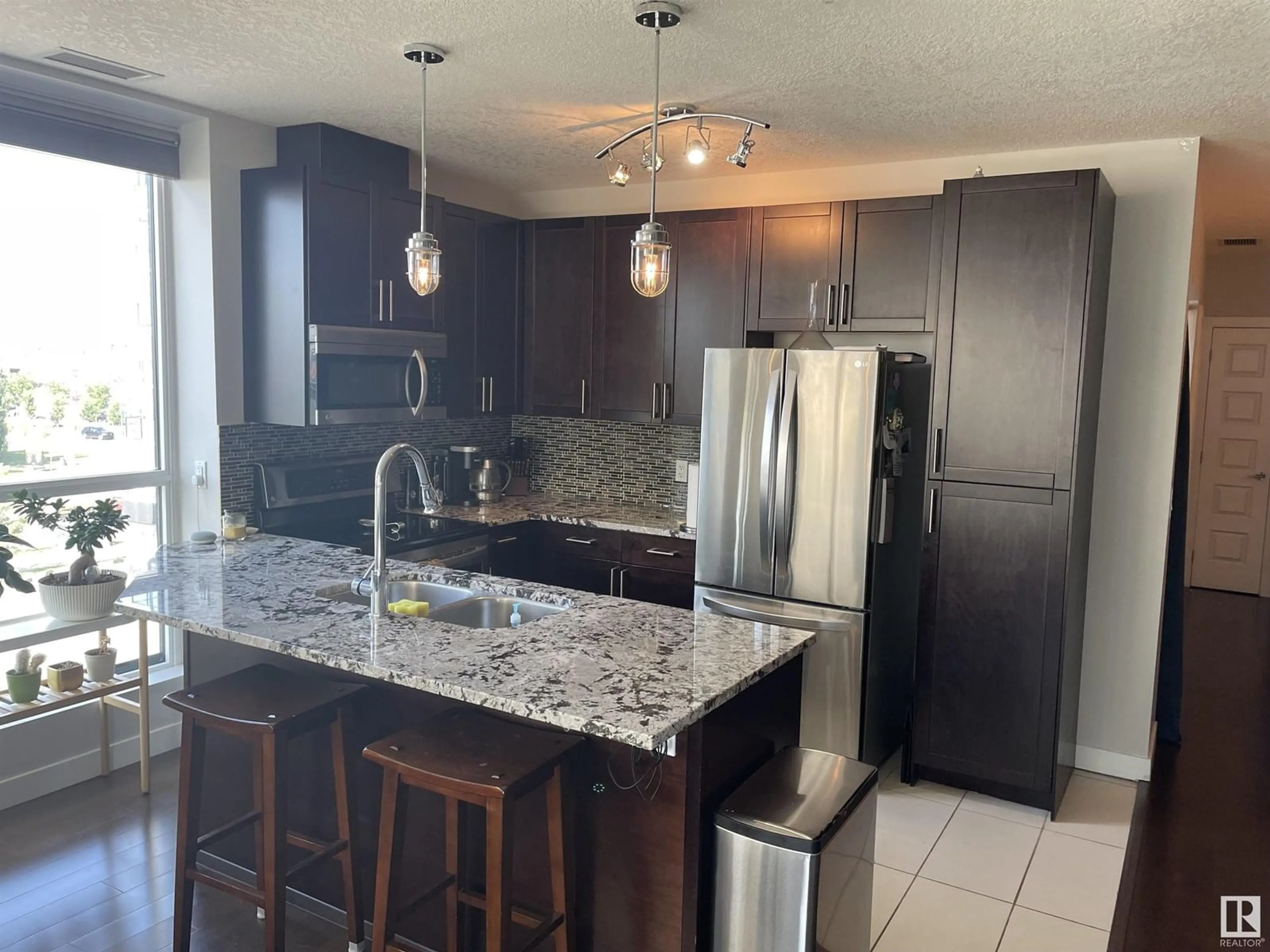 Open concept kitchen, ceramic/tile floor for #416 - 5151 WINDERMERE BV, Edmonton Alberta T6W2K4