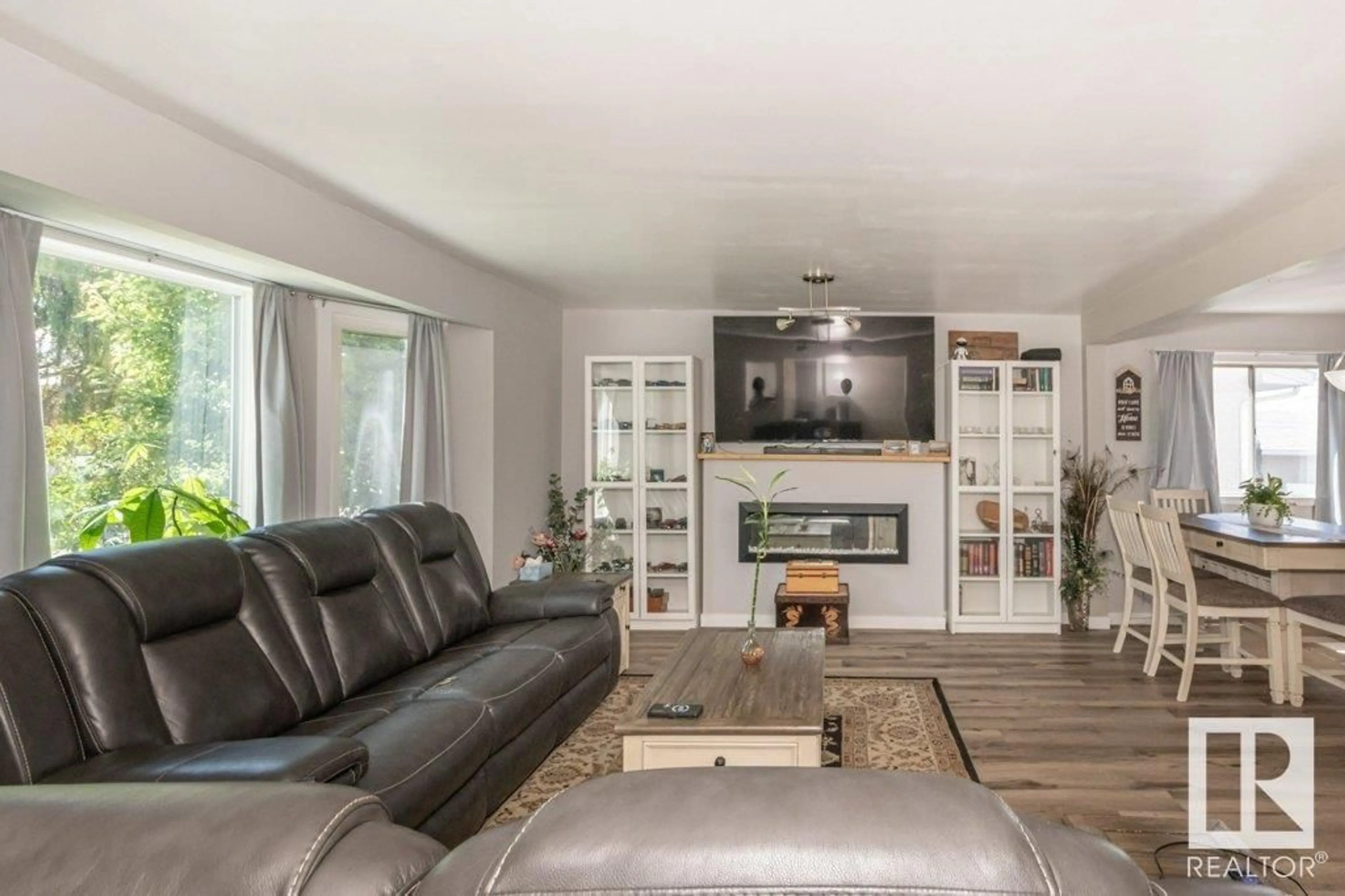 Living room with furniture, wood/laminate floor for NW - 3506 122 AV, Edmonton Alberta T5W1P8