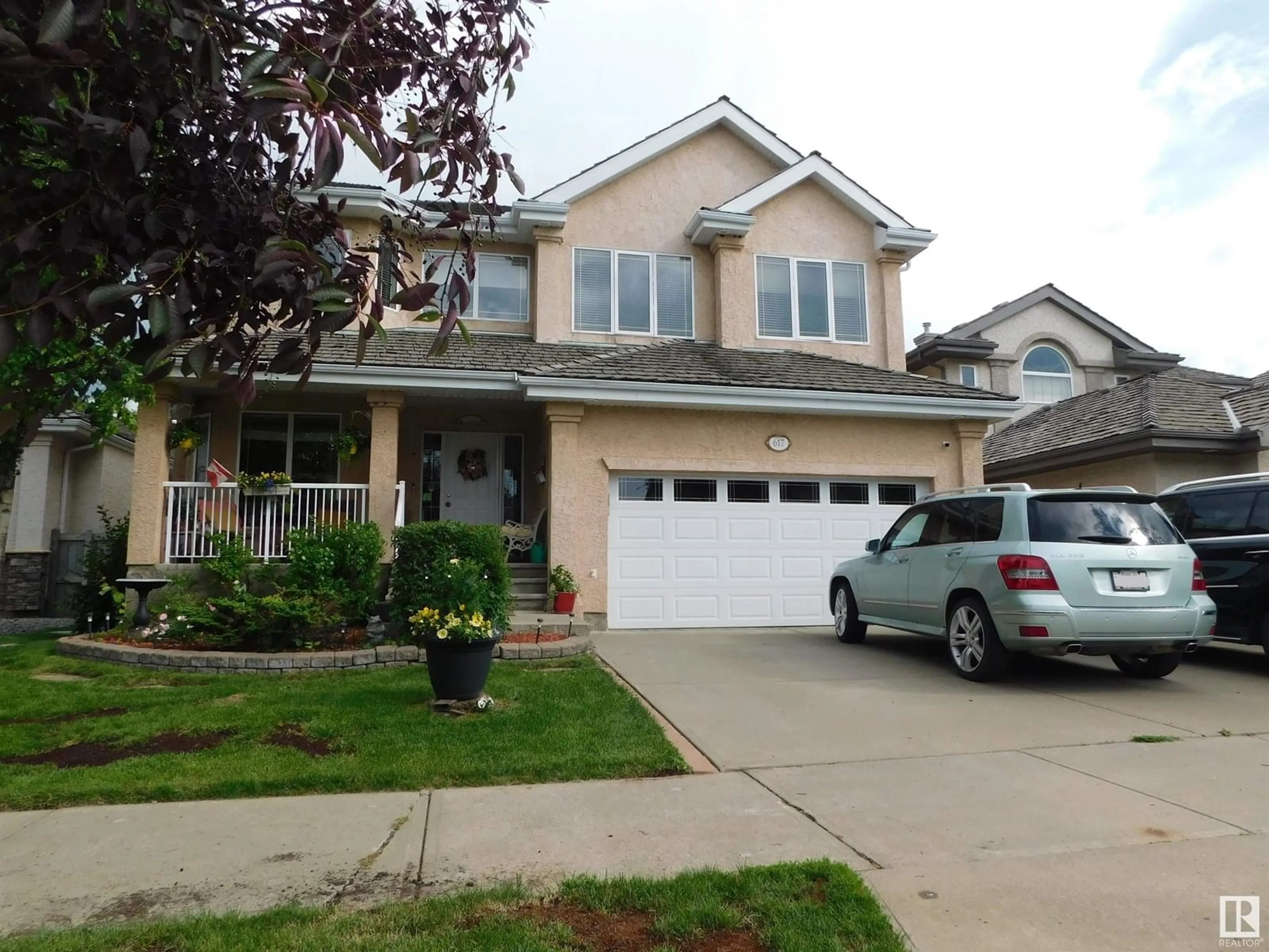 Home with vinyl exterior material, street for 617 DALHOUSIE CR, Edmonton Alberta T6M2T4