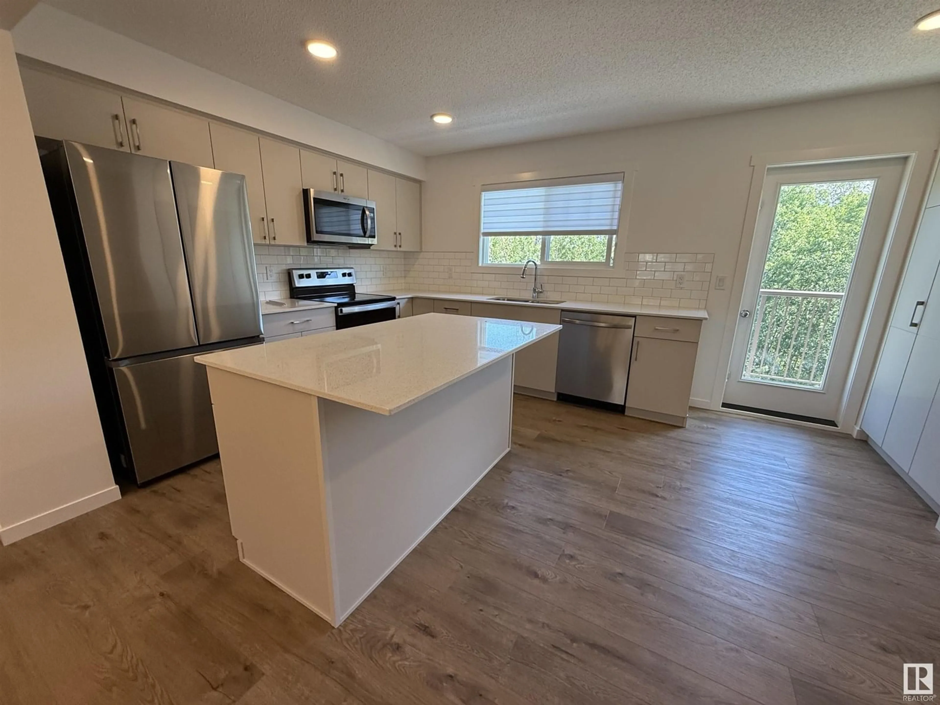 Open concept kitchen, wood/laminate floor for #17 - 50 MCLAUGHLIN DR, Spruce Grove Alberta T7X0E1