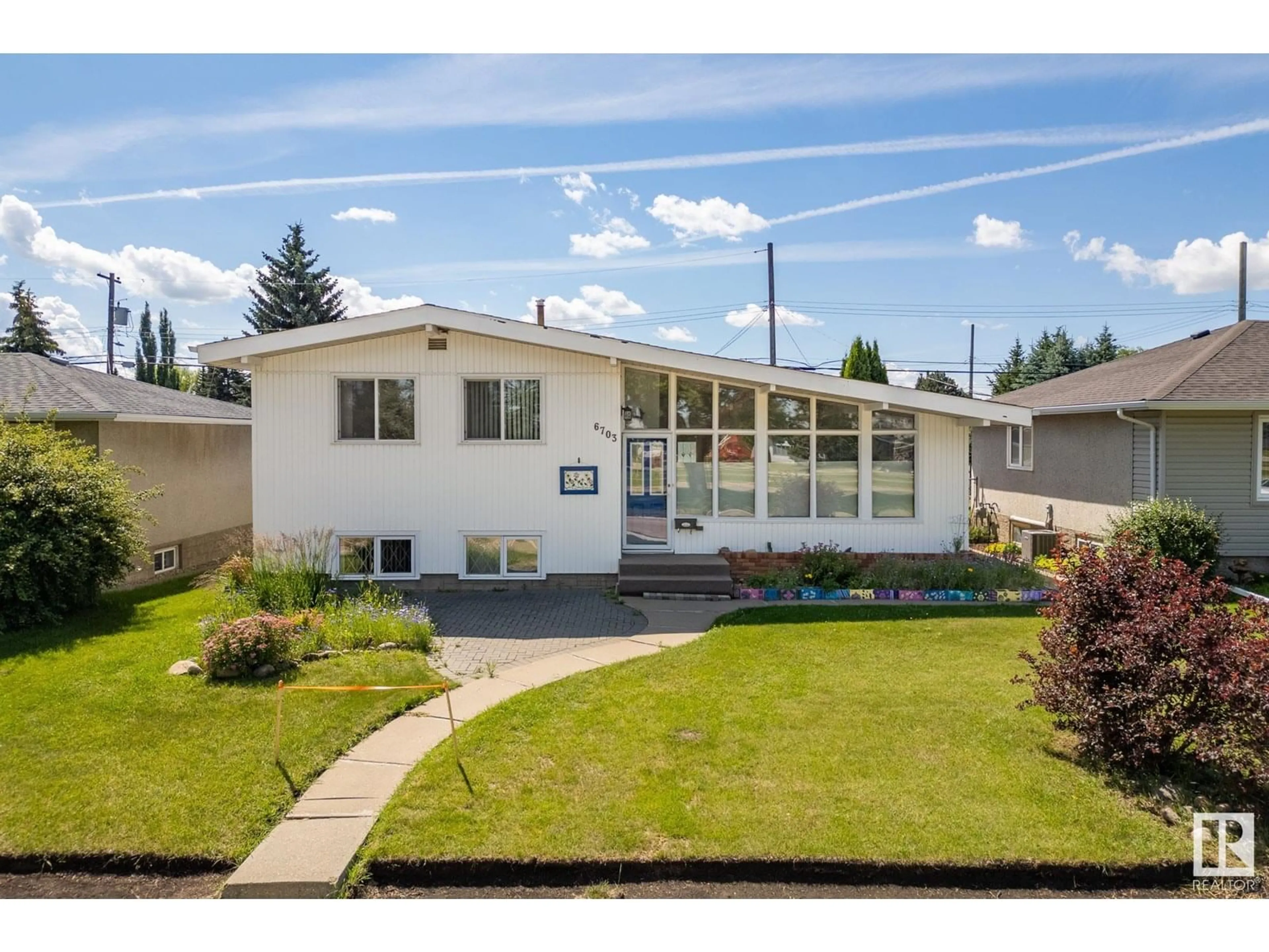 Home with vinyl exterior material, street for 6703 98 AV, Edmonton Alberta T6A0A4