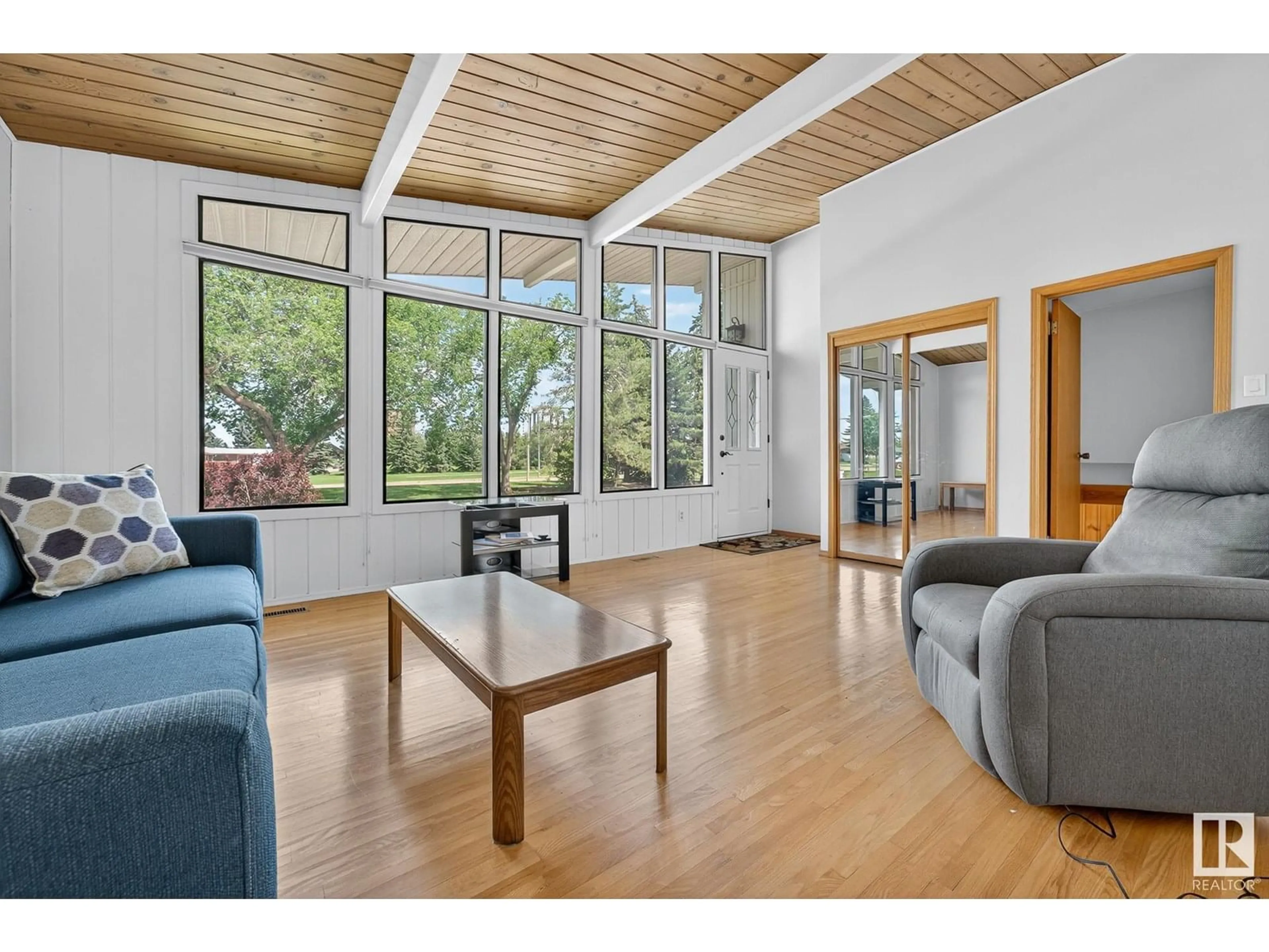 Living room with furniture, wood/laminate floor for 6703 98 AV, Edmonton Alberta T6A0A4