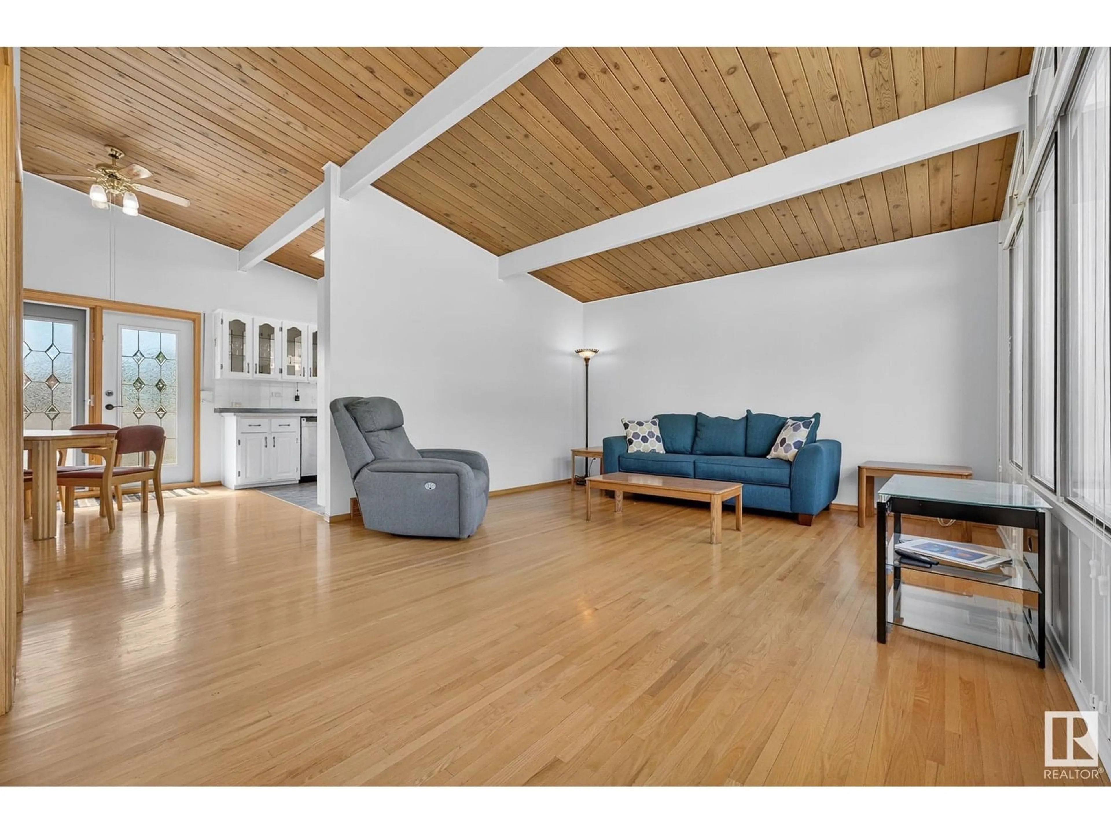 Living room with furniture, wood/laminate floor for 6703 98 AV, Edmonton Alberta T6A0A4