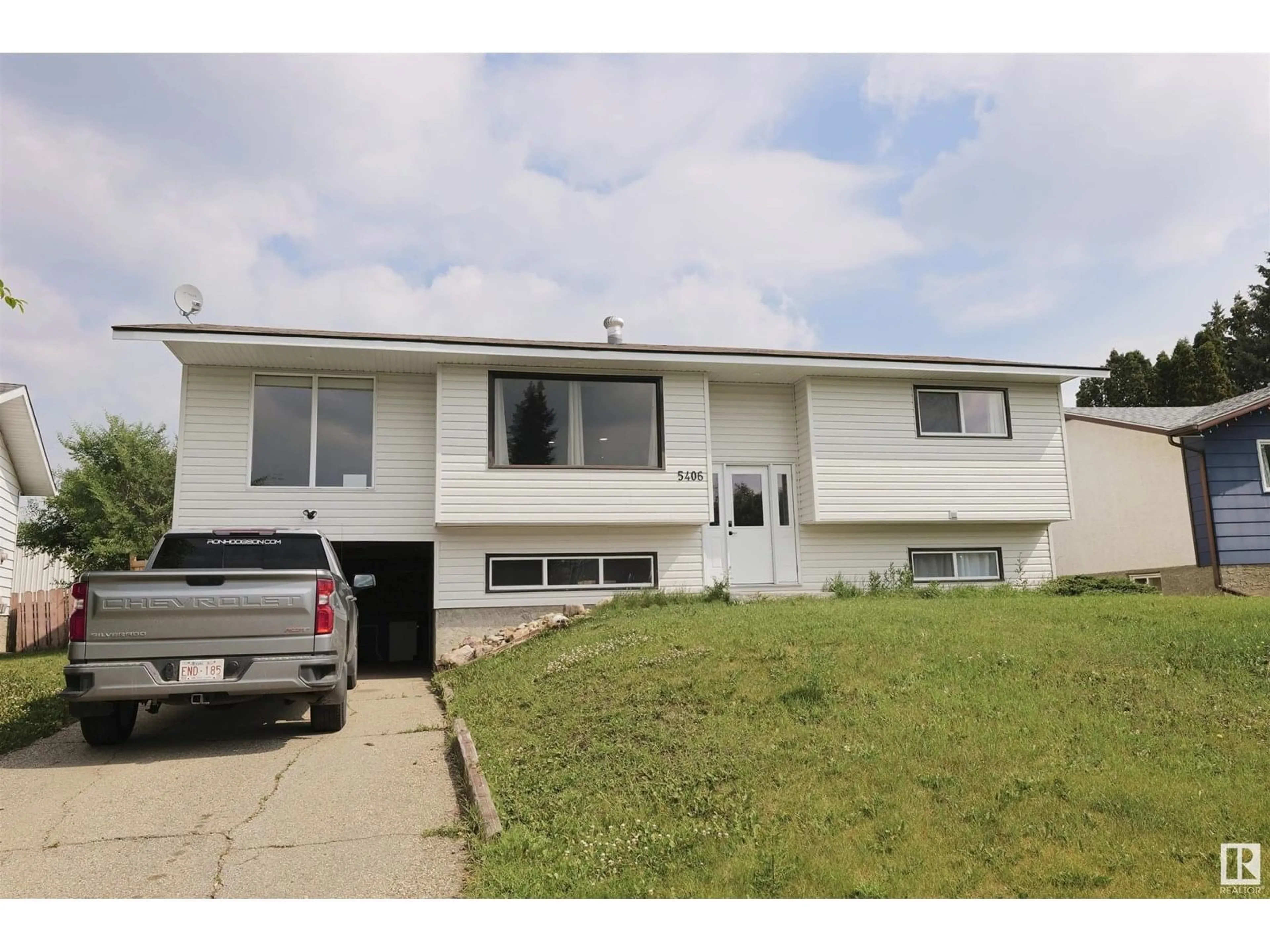 Home with vinyl exterior material, street for 5406 49 AV, Barrhead Alberta T7N1G2