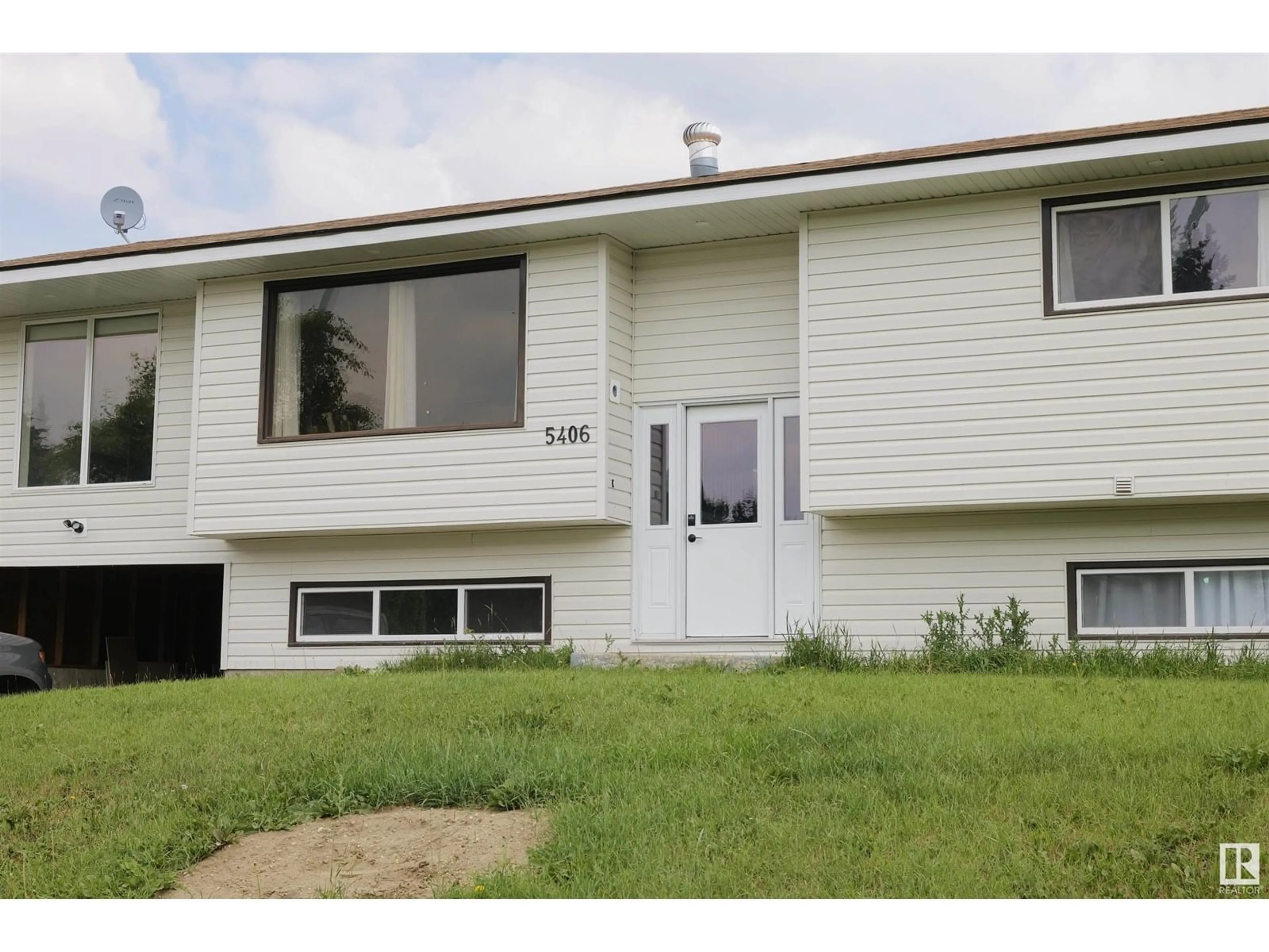 Home with vinyl exterior material, street for 5406 49 AV, Barrhead Alberta T7N1G2