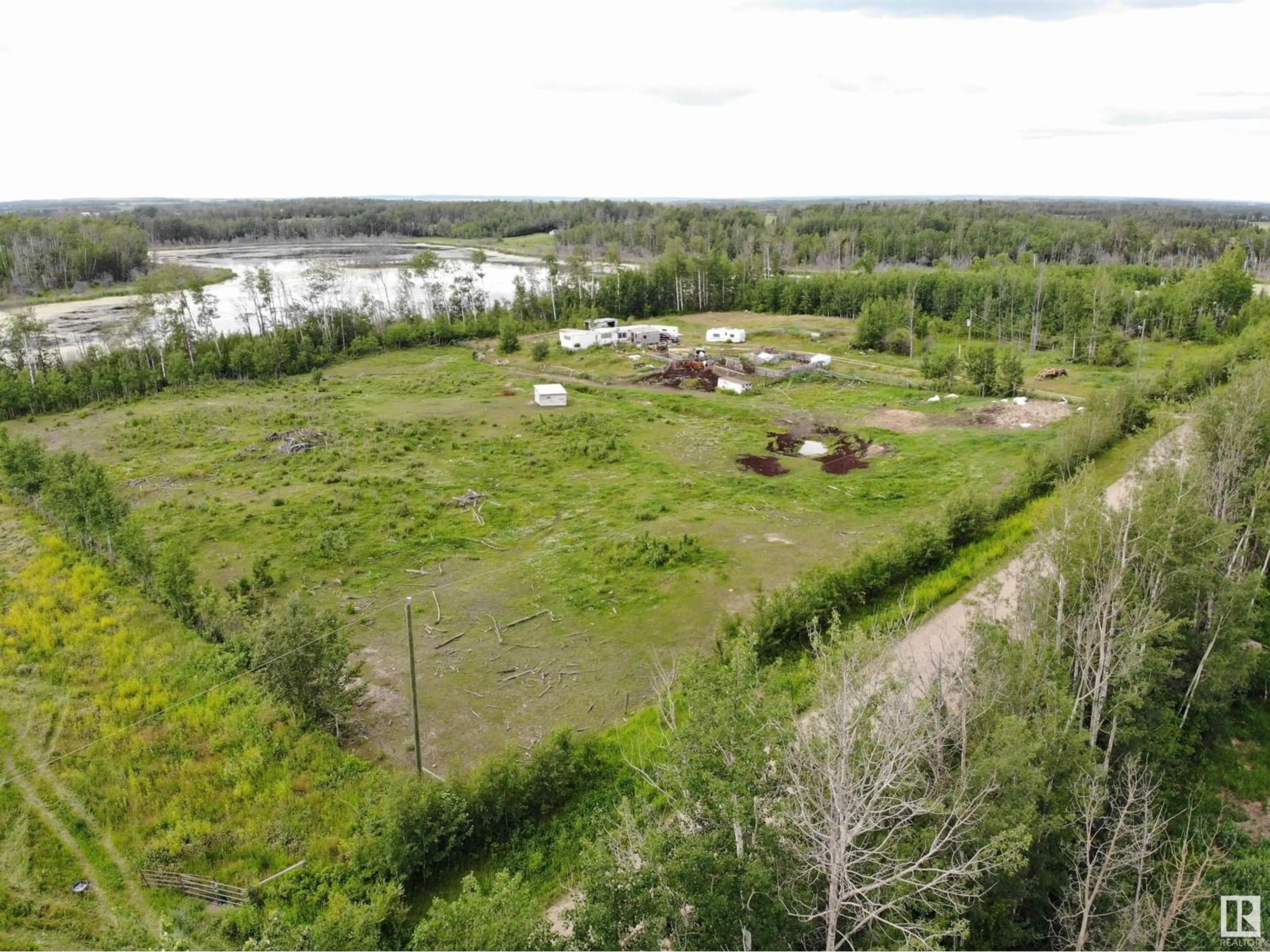 A pic from outside/outdoor area/front of a property/back of a property/a pic from drone, water/lake/river/ocean view for 58124 RGE RD 43, Rural Barrhead County Alberta T7N1N4