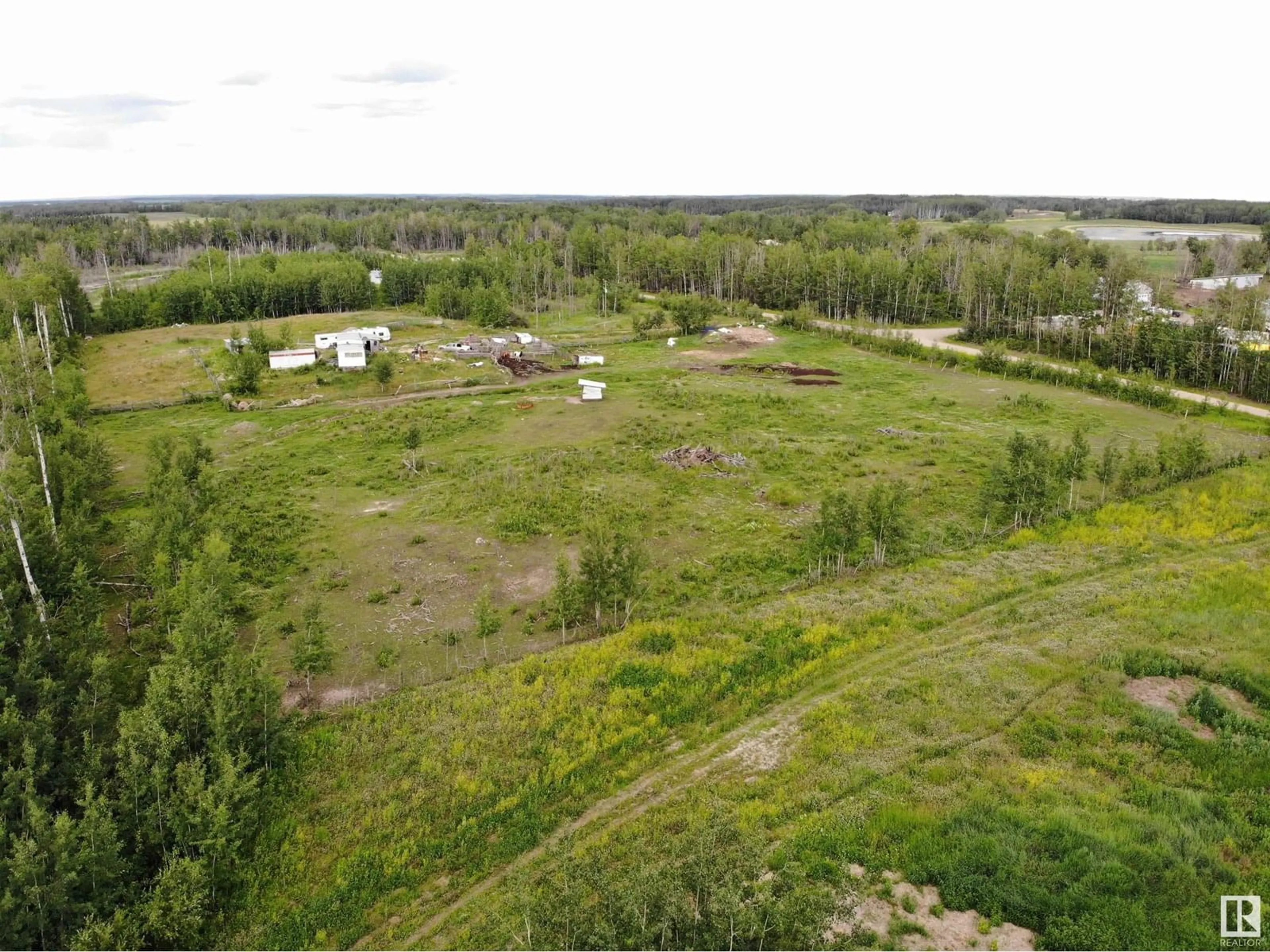 A pic from outside/outdoor area/front of a property/back of a property/a pic from drone, forest/trees view for 58124 RGE RD 43, Rural Barrhead County Alberta T7N1N4