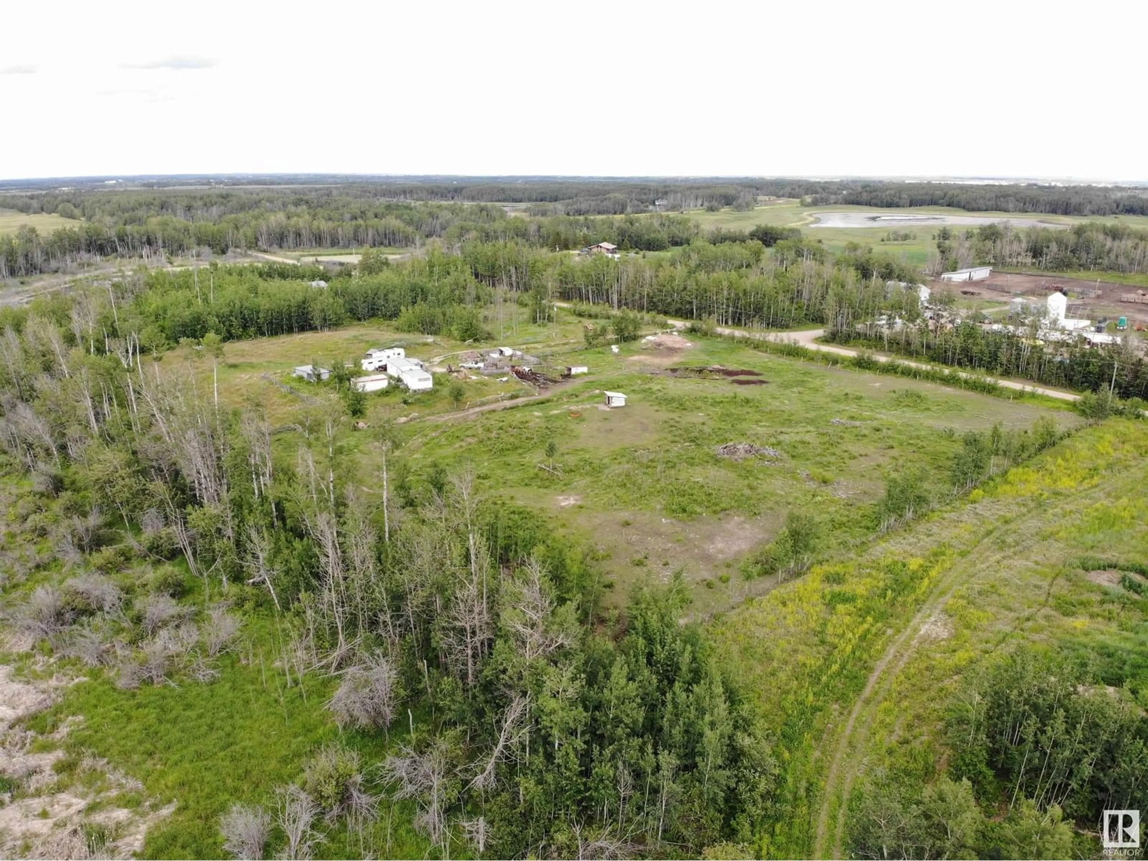 A pic from outside/outdoor area/front of a property/back of a property/a pic from drone, forest/trees view for 58124 RGE RD 43, Rural Barrhead County Alberta T7N1N4