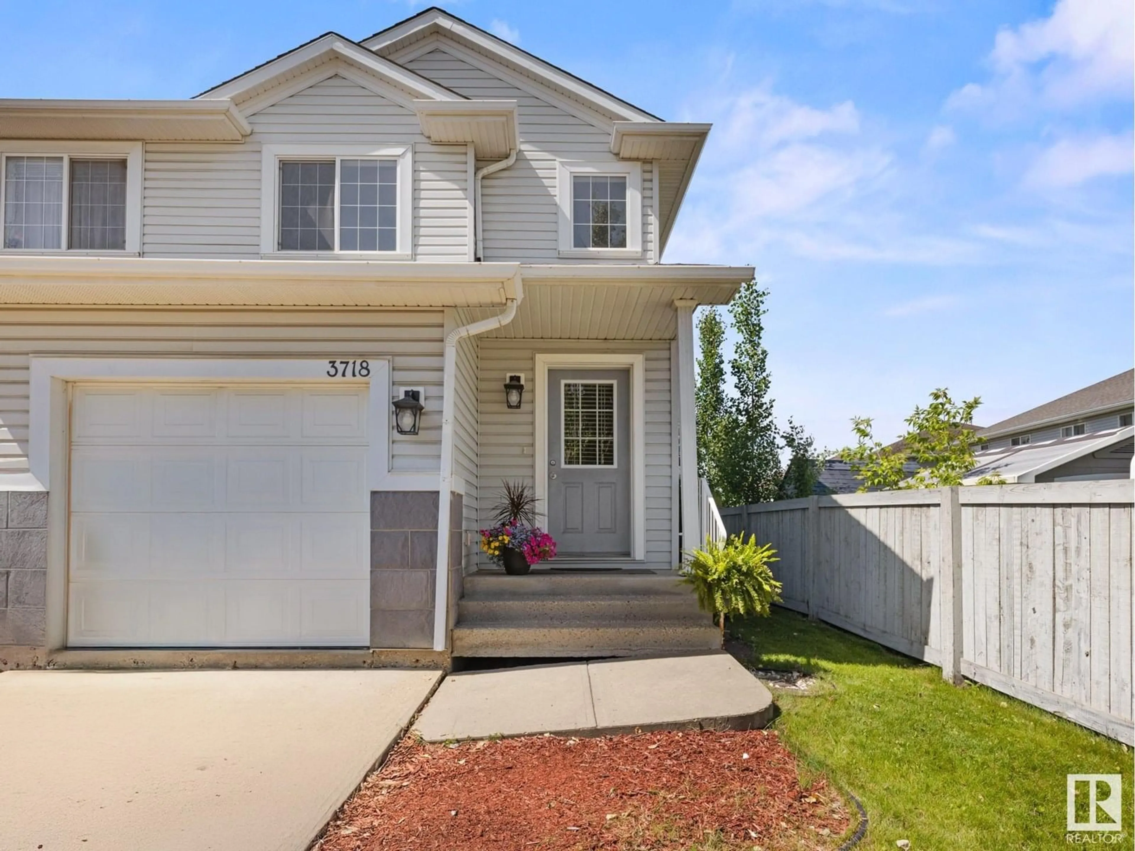 Home with vinyl exterior material, street for NW - 3718 138A AV, Edmonton Alberta T5Y3G5