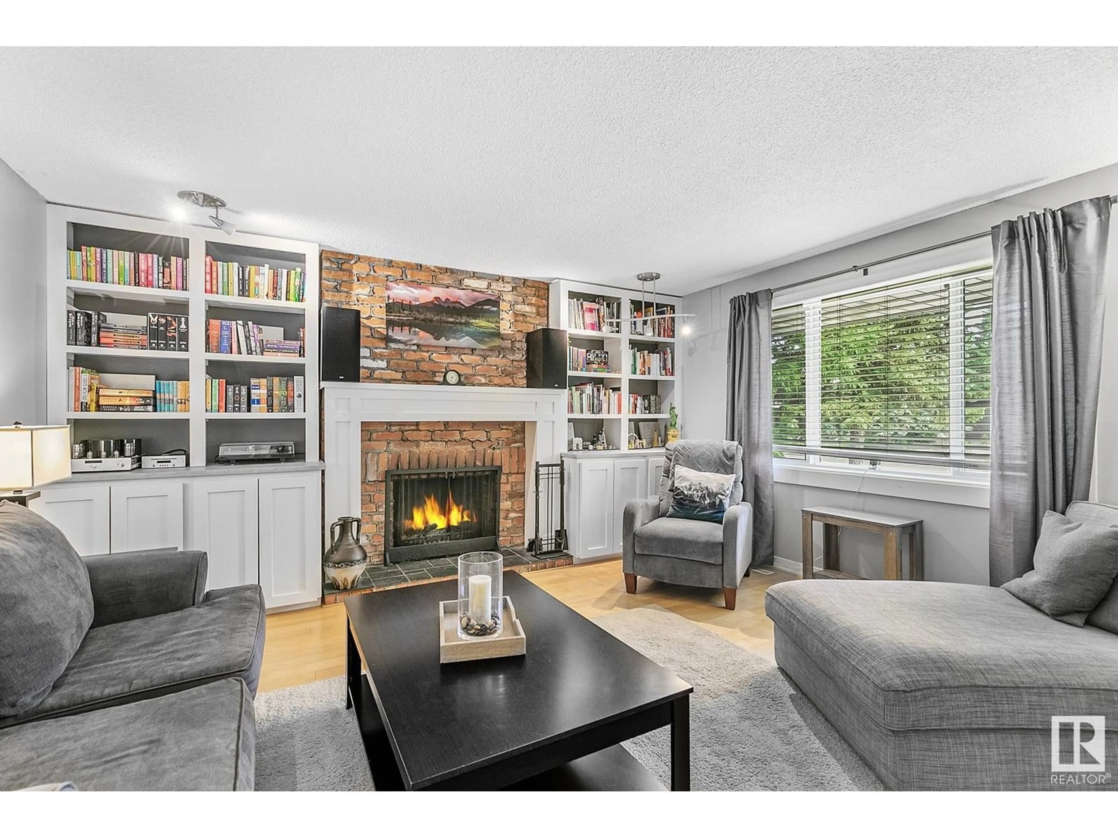 Living room with furniture, wood/laminate floor for NW - 7316 156 ST, Edmonton Alberta T5R1X3