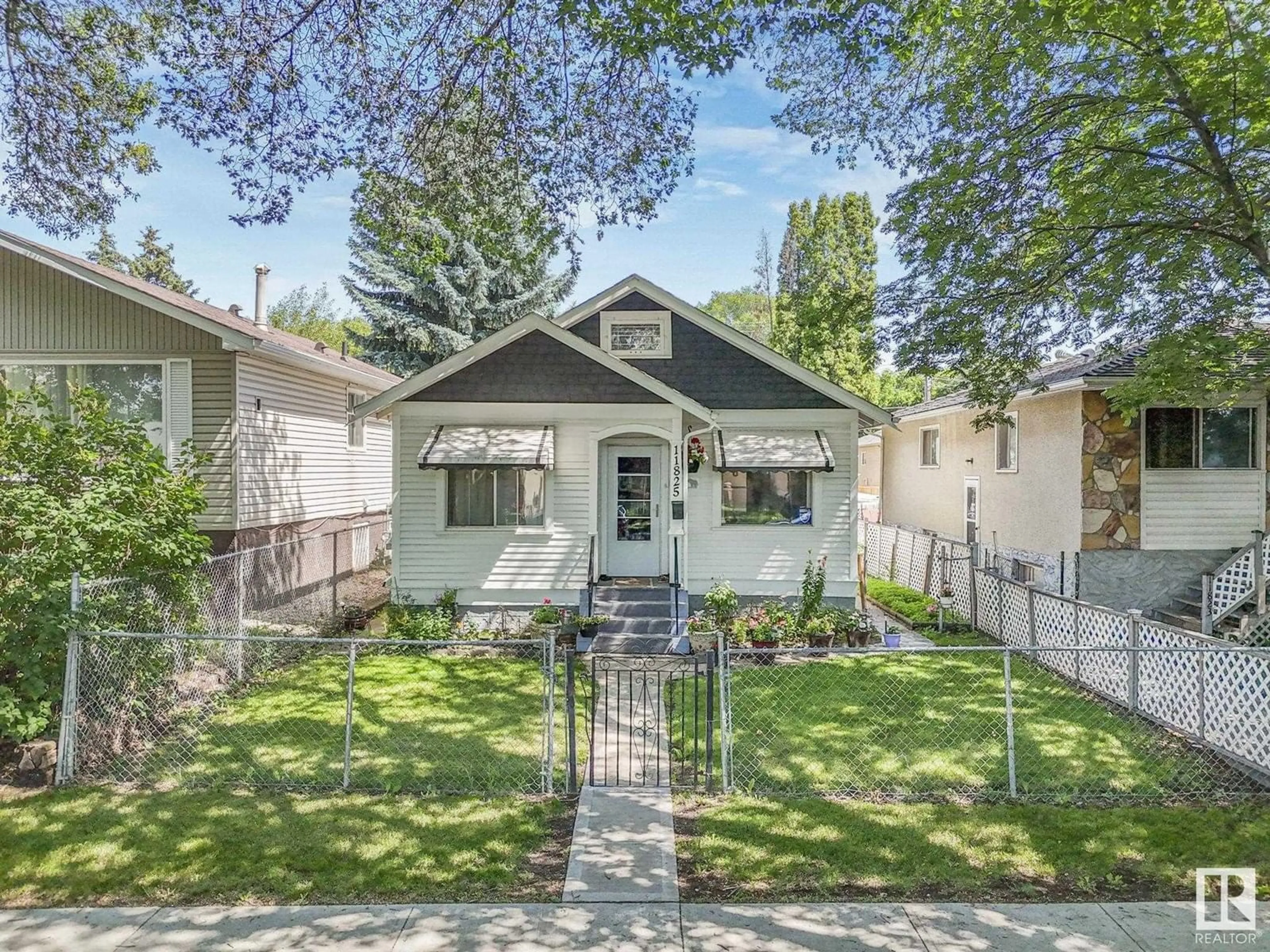 Home with vinyl exterior material, street for 11825 70 STREET NW, Edmonton Alberta T5B1T8