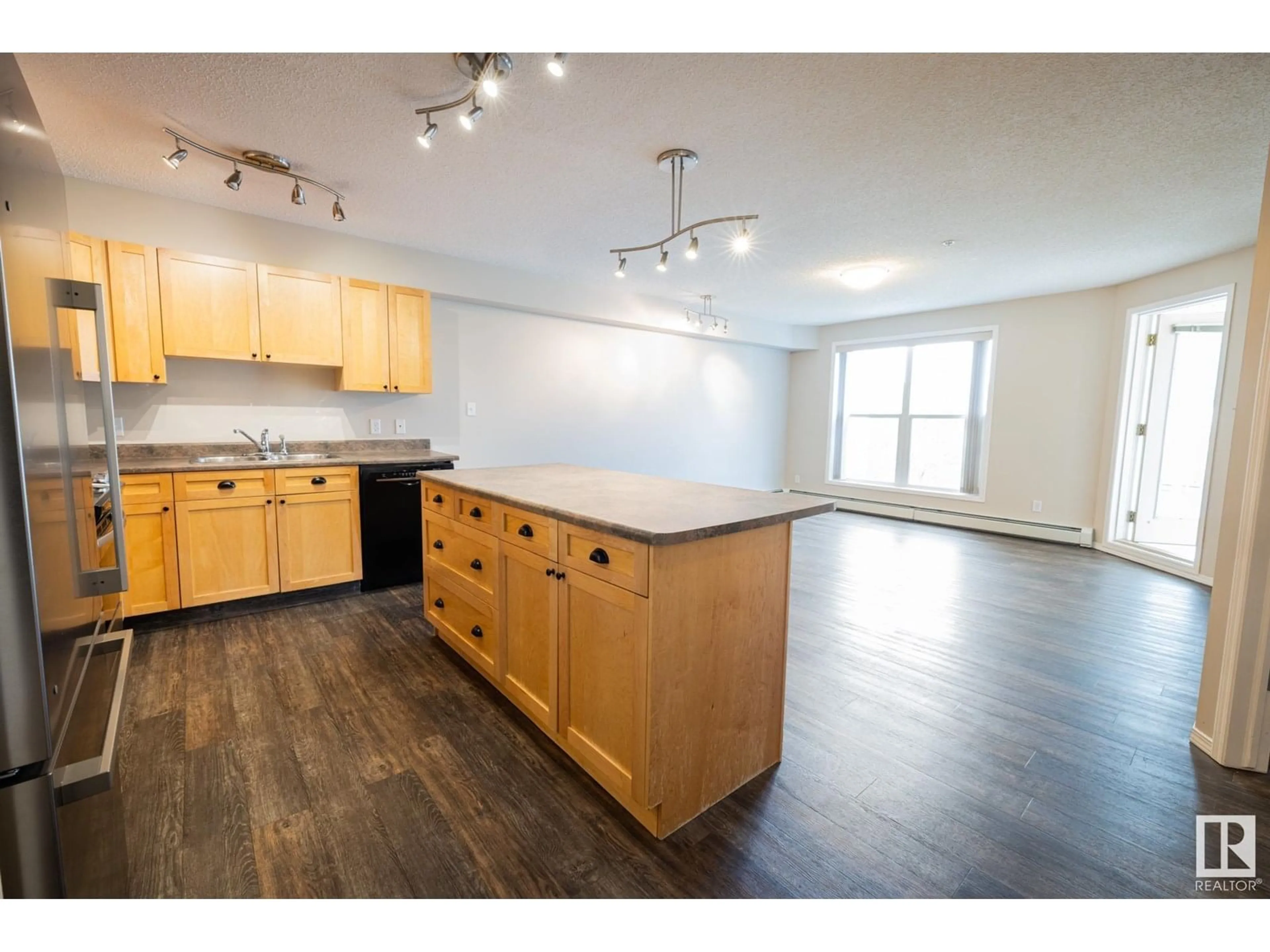 Open concept kitchen, wood/laminate floor for #406 - 10311 111 ST NW, Edmonton Alberta T5K2Y8