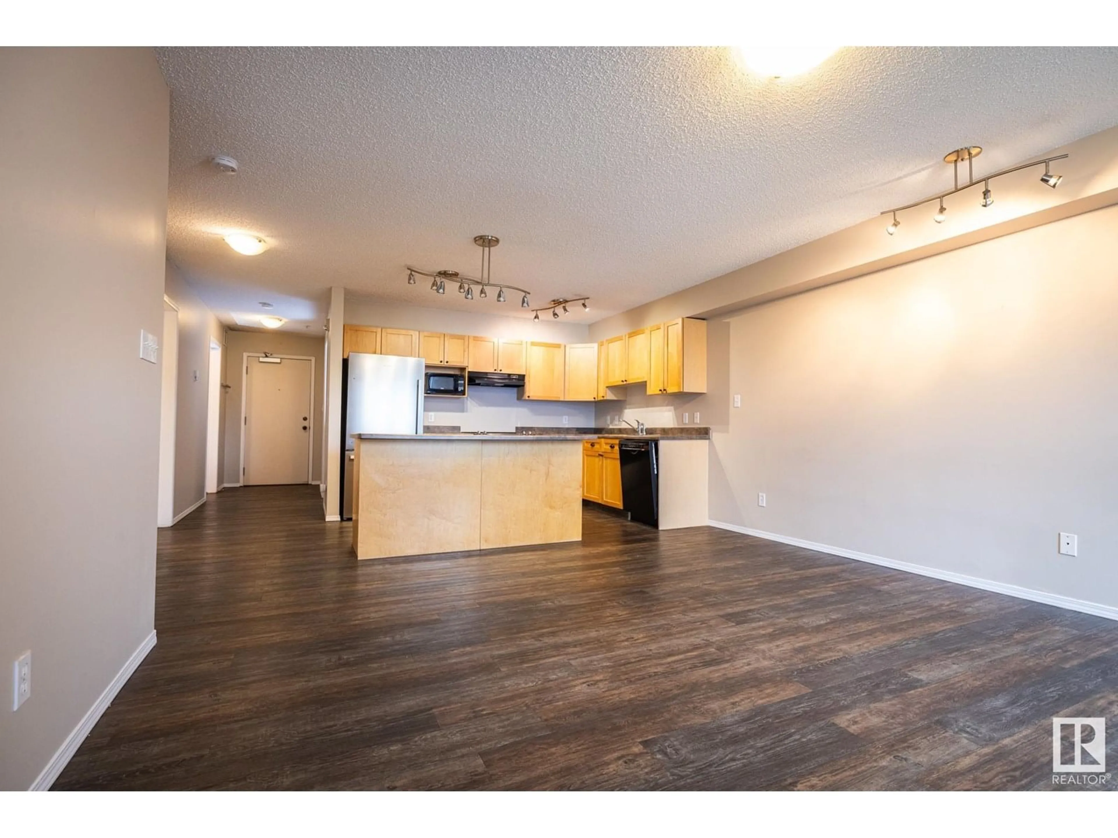 Open concept kitchen, wood/laminate floor for #406 - 10311 111 ST NW, Edmonton Alberta T5K2Y8