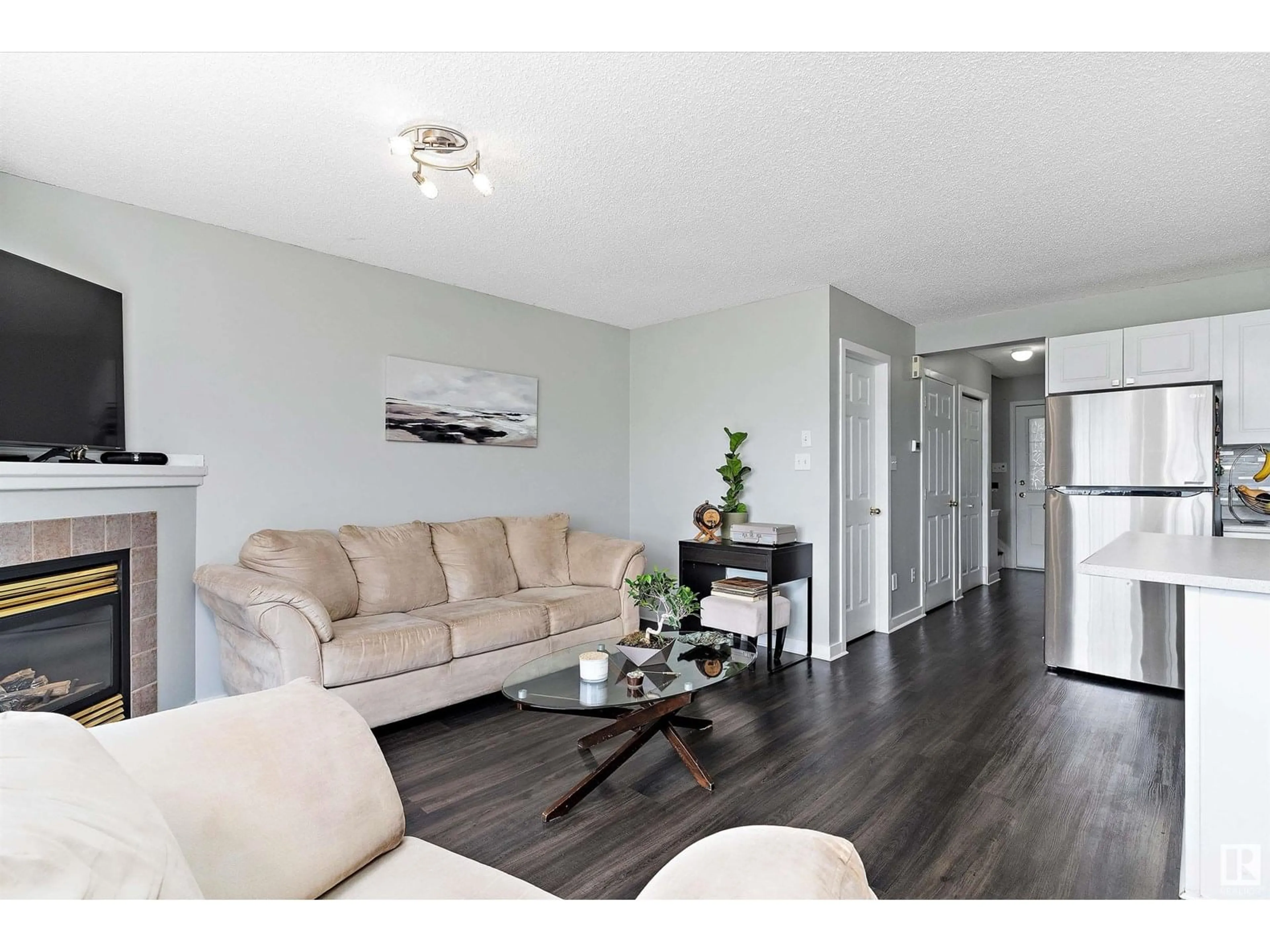 Living room with furniture, wood/laminate floor for 14803 - 21 MILLER BV, Edmonton Alberta T5Y3A4