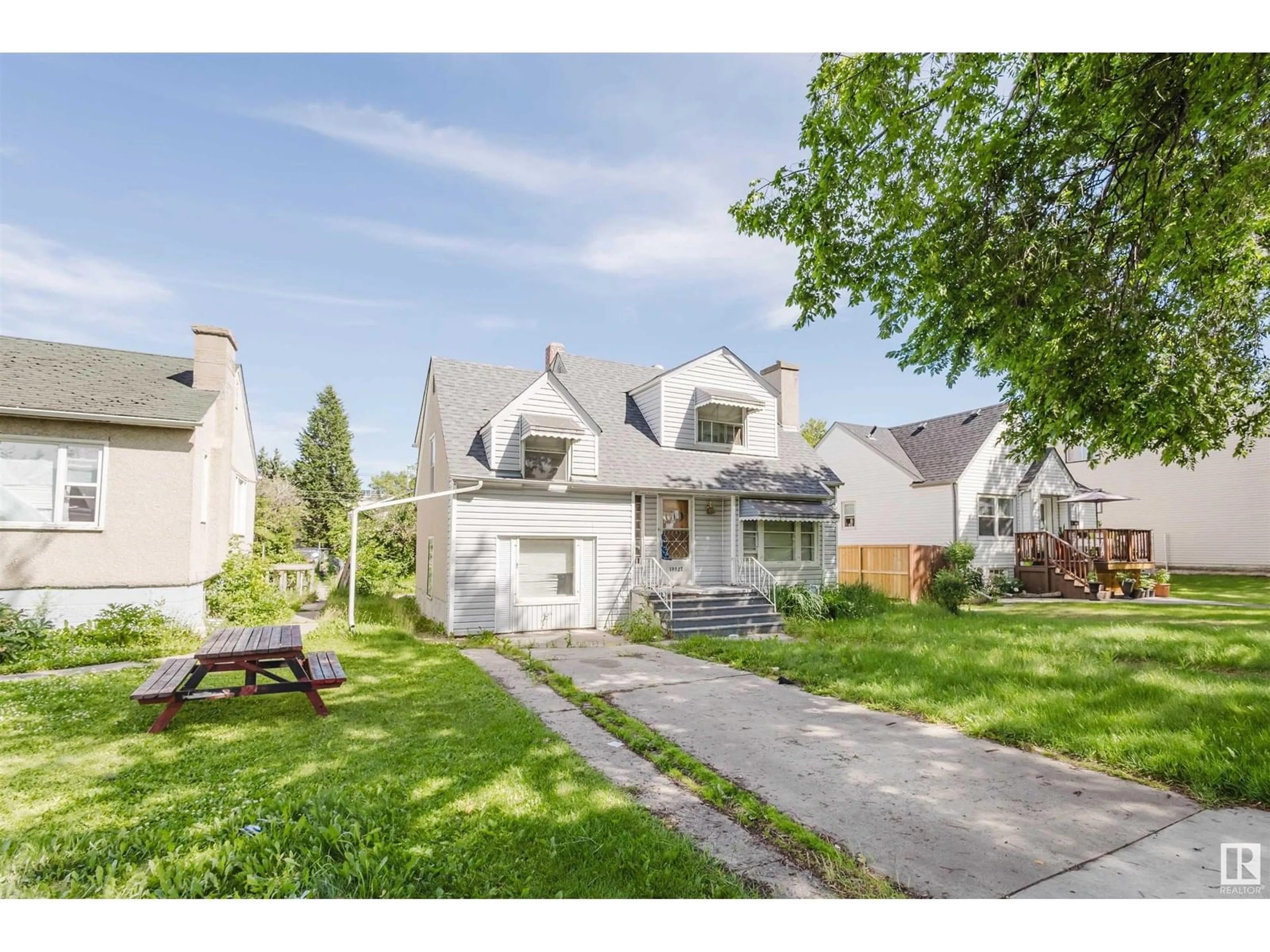 Home with vinyl exterior material, street for 10827 111 ST, Edmonton Alberta T5H3G5