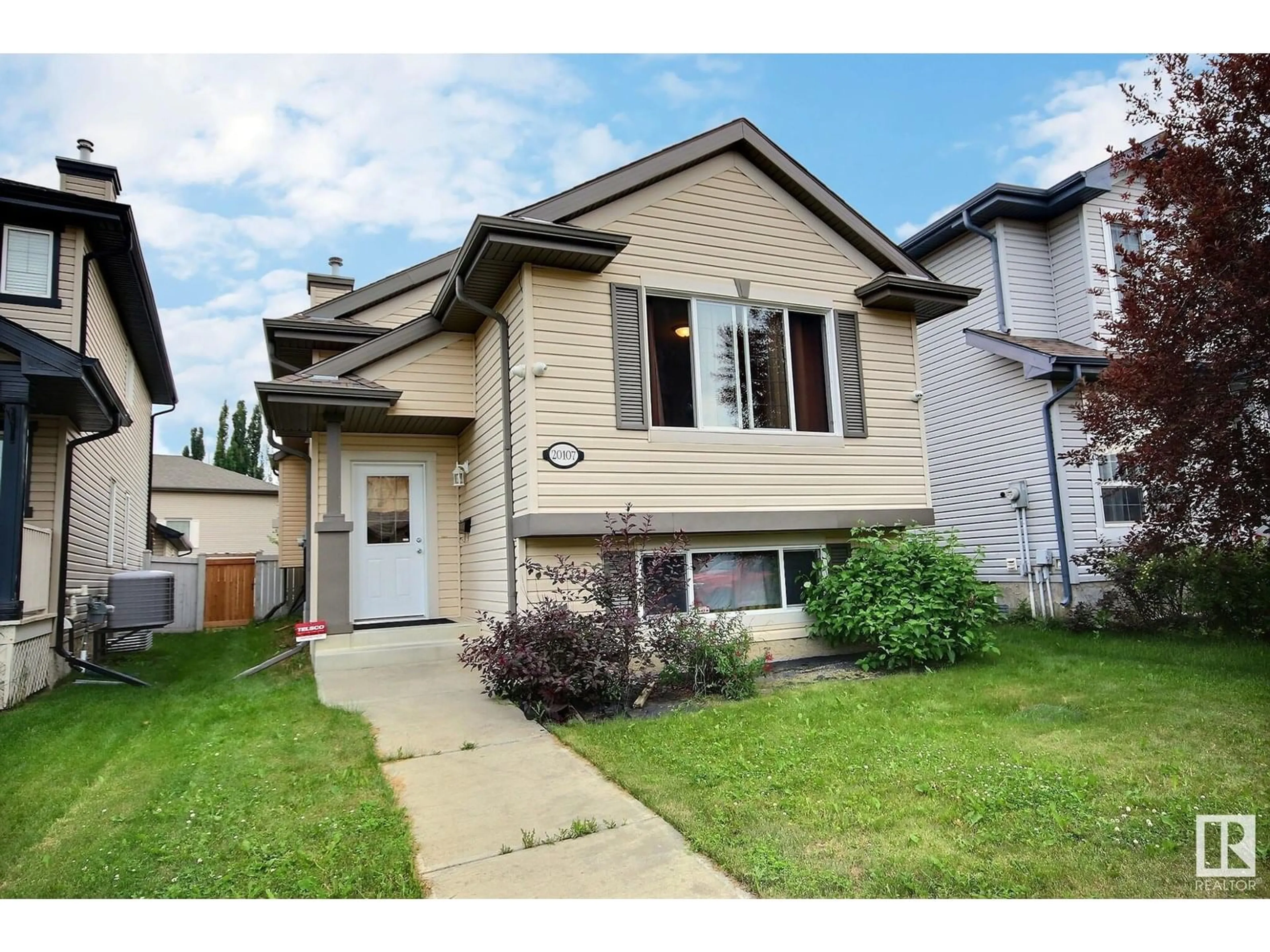 Home with vinyl exterior material, street for 20107 58 AV, Edmonton Alberta T6M0B4