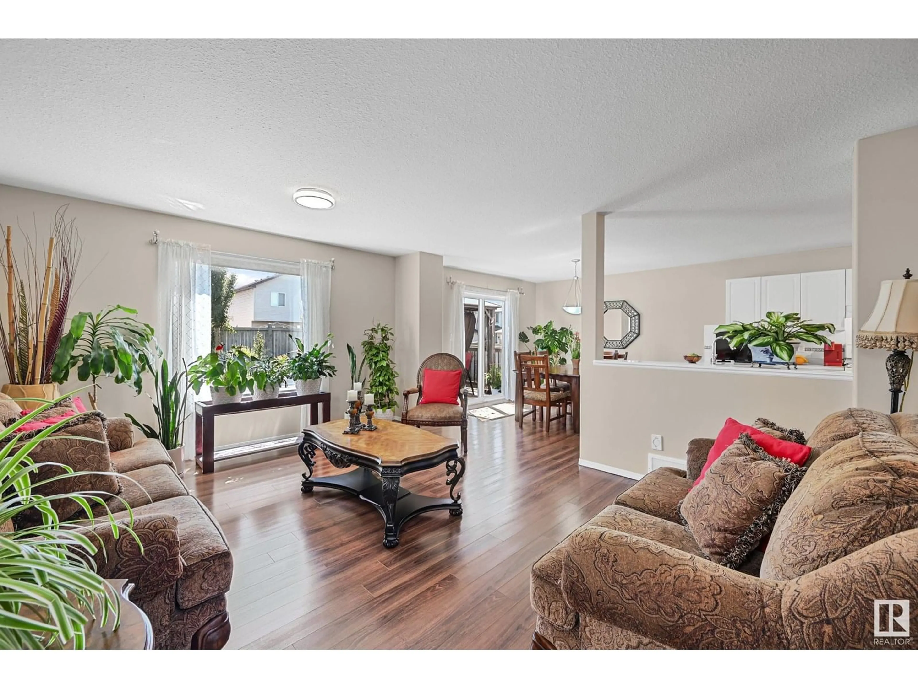 Living room with furniture, wood/laminate floor for 3371 25 AV, Edmonton Alberta T6T1Y4