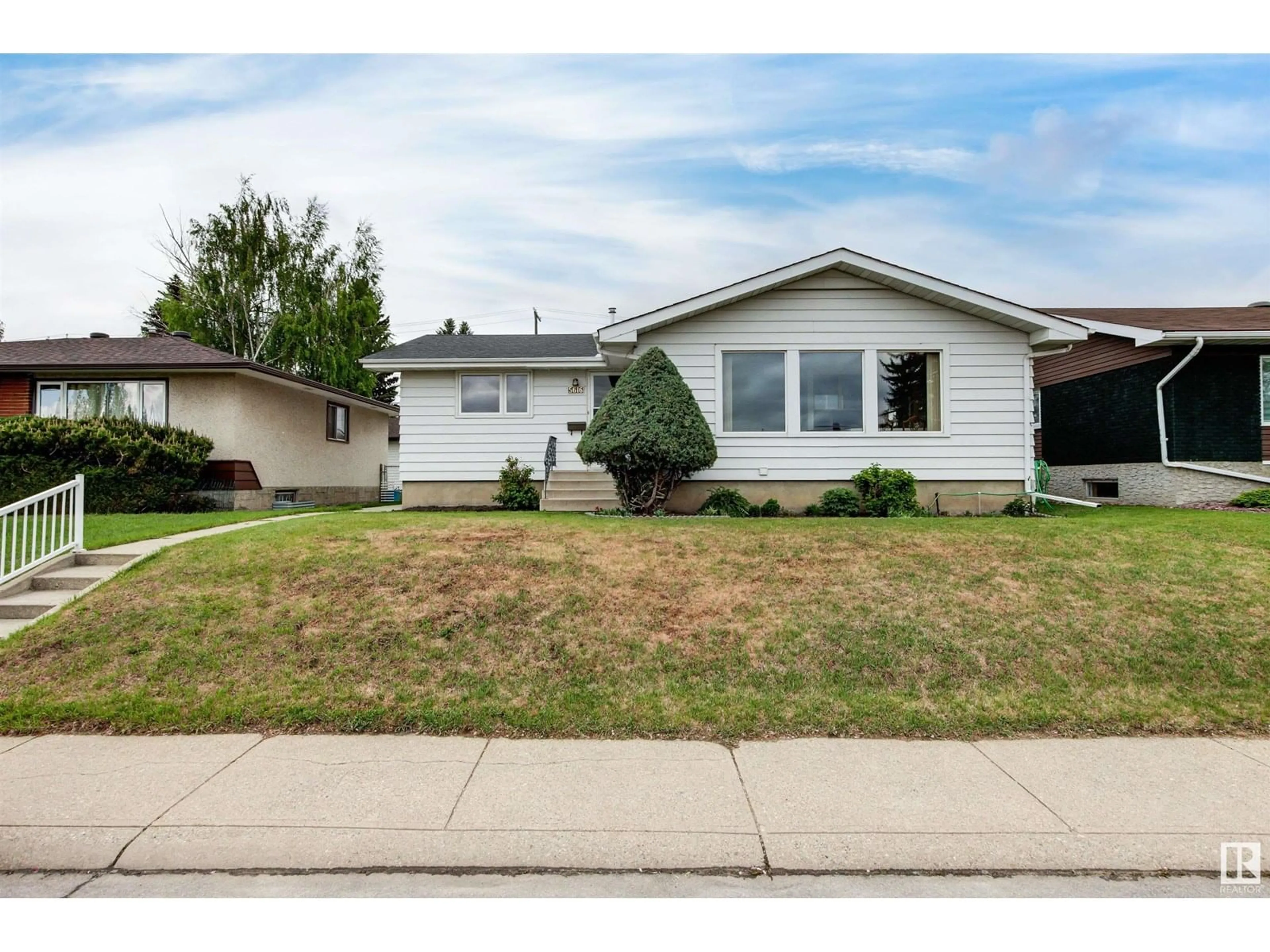 Home with vinyl exterior material, street for NW - 5616 140A AV, Edmonton Alberta T5A1H3
