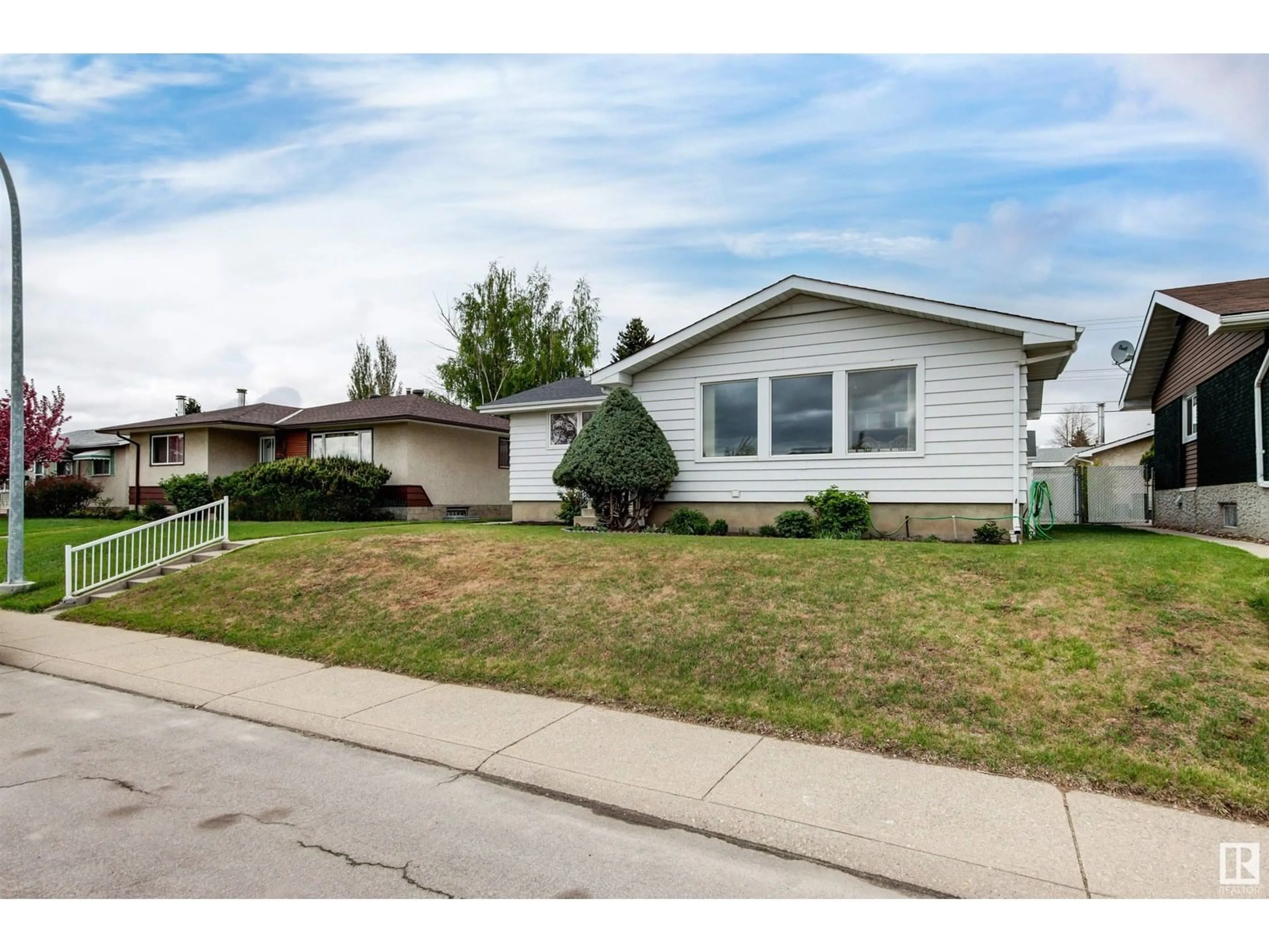 Home with vinyl exterior material, street for NW - 5616 140A AV, Edmonton Alberta T5A1H3